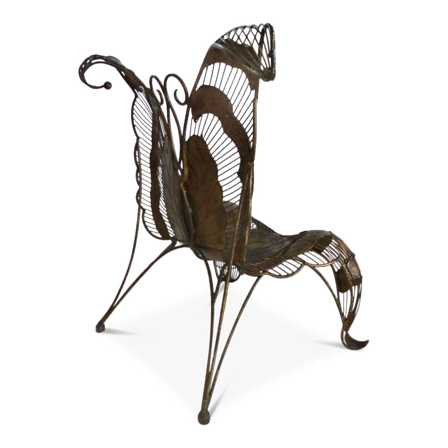 Grand sculptural lounge chair forged to create an impressive butterfly in a subtle blend of copper and gold tones with etched details on the solid components of the design. These solid parts are welded together with thin reeds of iron to create the