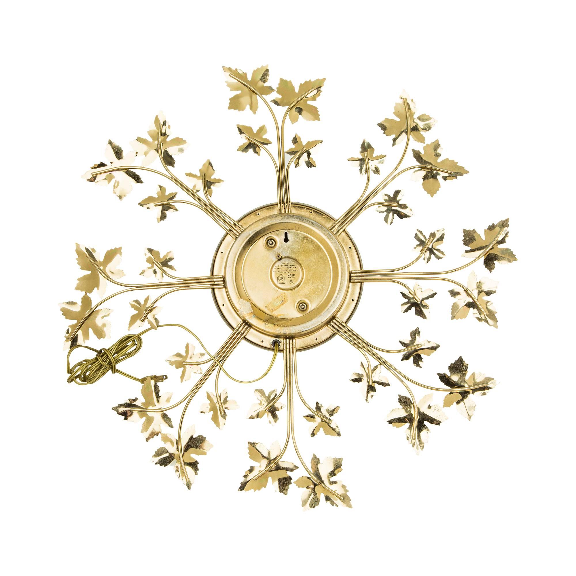 Attractive and fun sunburst clock by United. Featuring brass ivy leaves decorated spindles with white and brass face and Roman numerals. Plug at the back. 

The archetypal design makes this clock appropriate for a number of locations, from classic