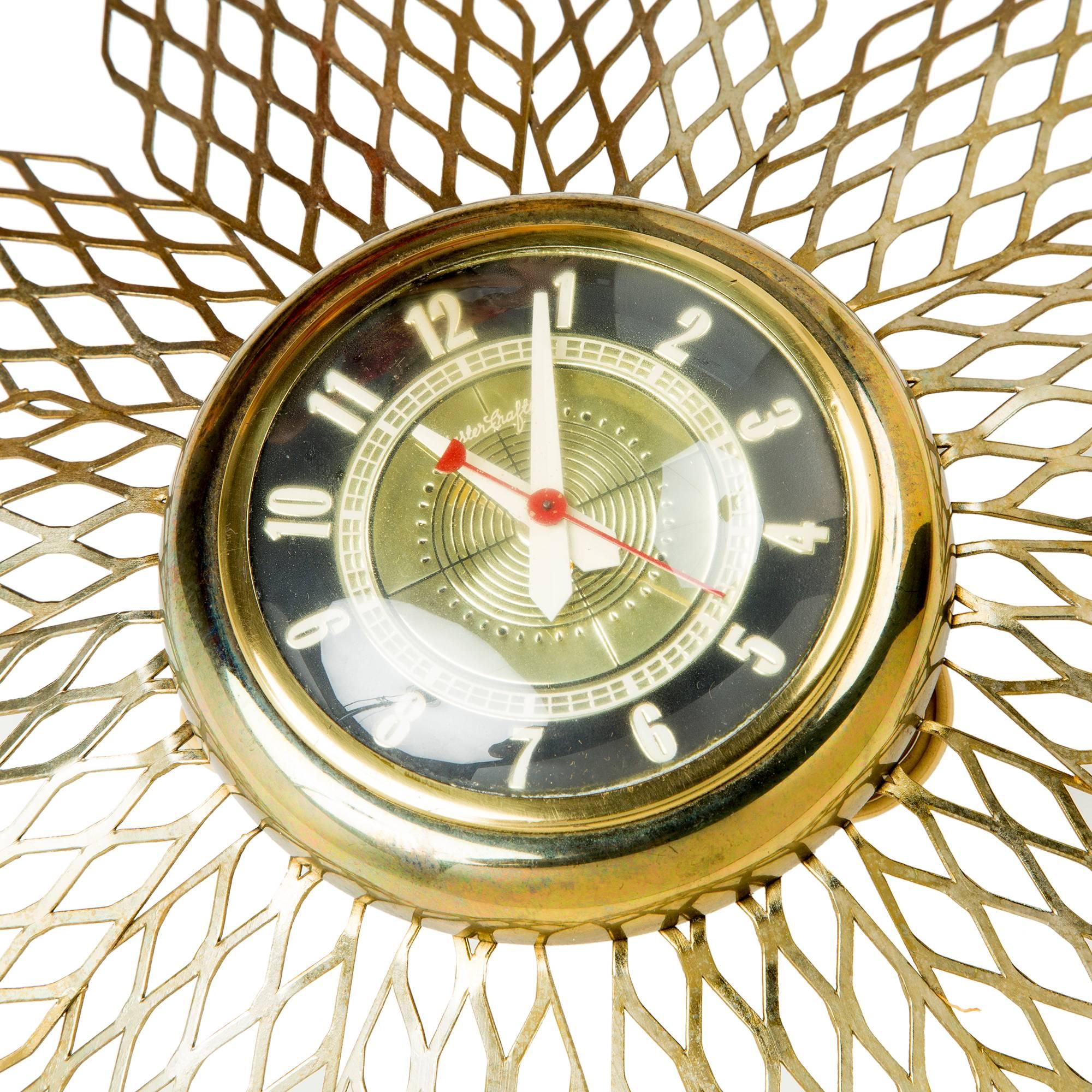 Wonderful starburst clock by Mastercrafters. Featuring cut-out wire detail with a black and brass face and red minute hand. Plugs at the back. We currently have two of these clocks available. 

The archetypal design makes this clock appropriate