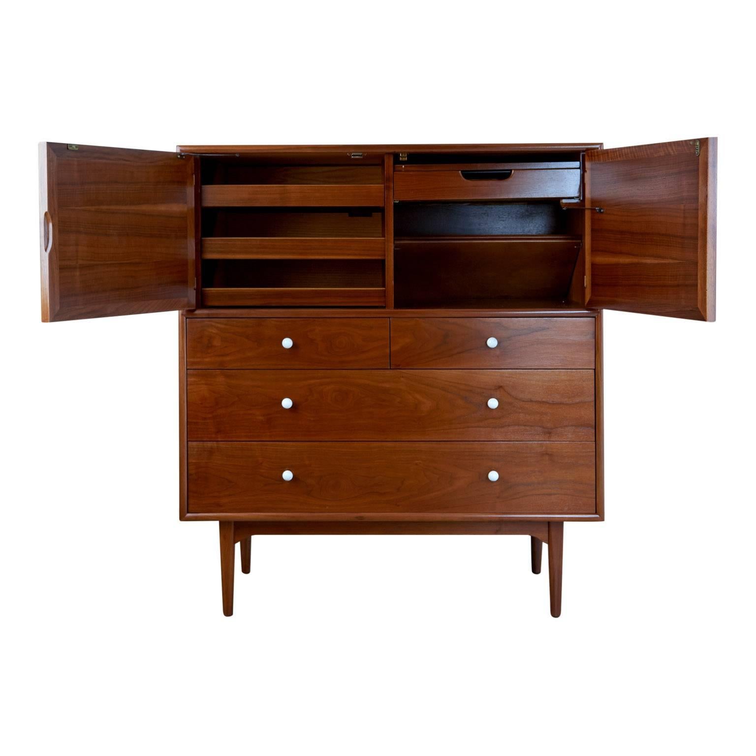 Exceptional Mid-Century Modern tallboy designed by Kipp Stewart and Stewart McDougall as part of the Declaration line for Drexel furniture. Fabricated from veneered walnut with striking wood grain and dovetail drawers this beautiful tallboy has been