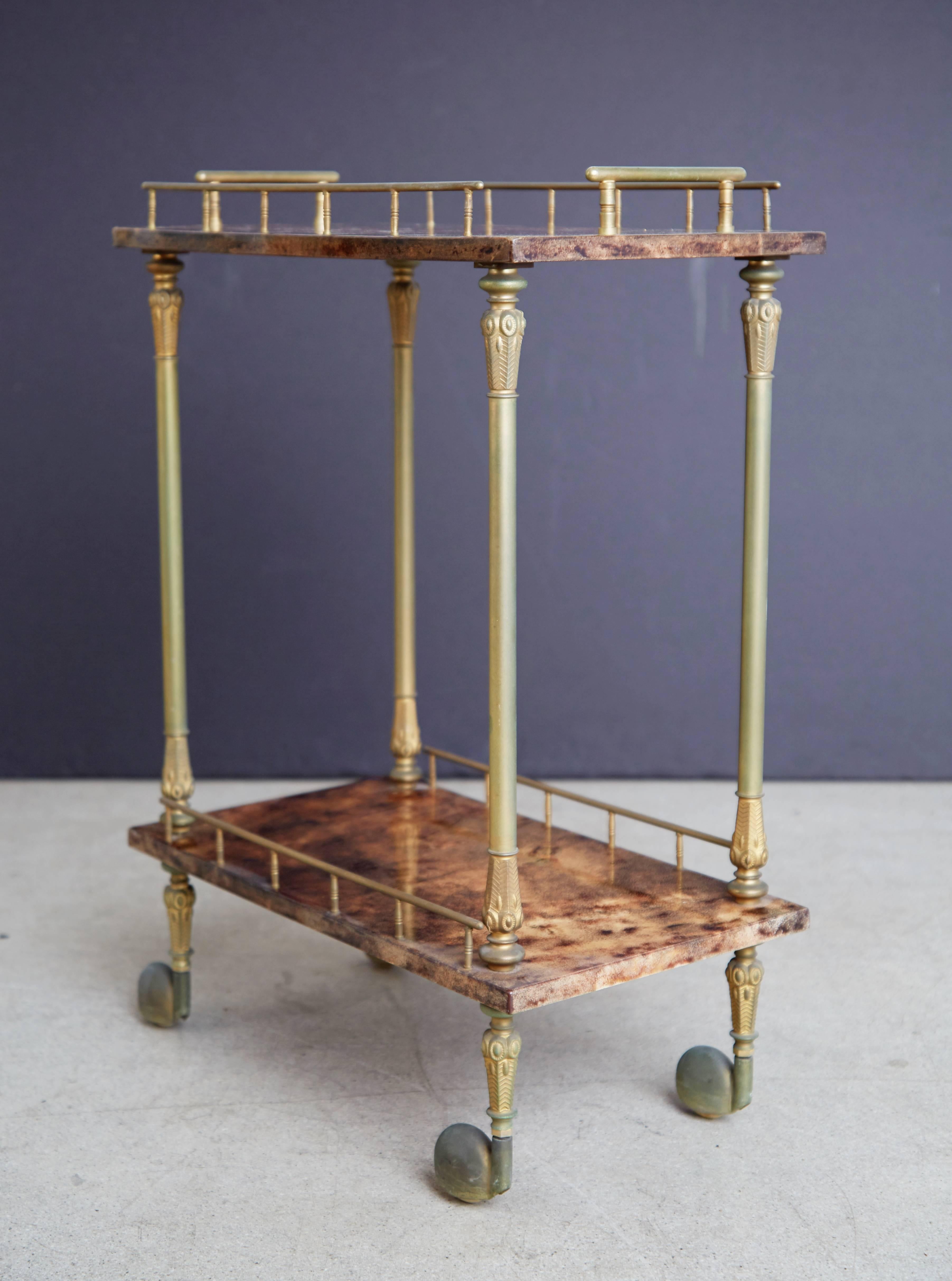 Beautiful petite bar cart by Italian artist-craftsman Aldo Tura, featuring the designers distinct use of goatskin that Tura was well-known for. The quality of Tura's craftsmanship can be attributed to the fact that his work was only produced in a