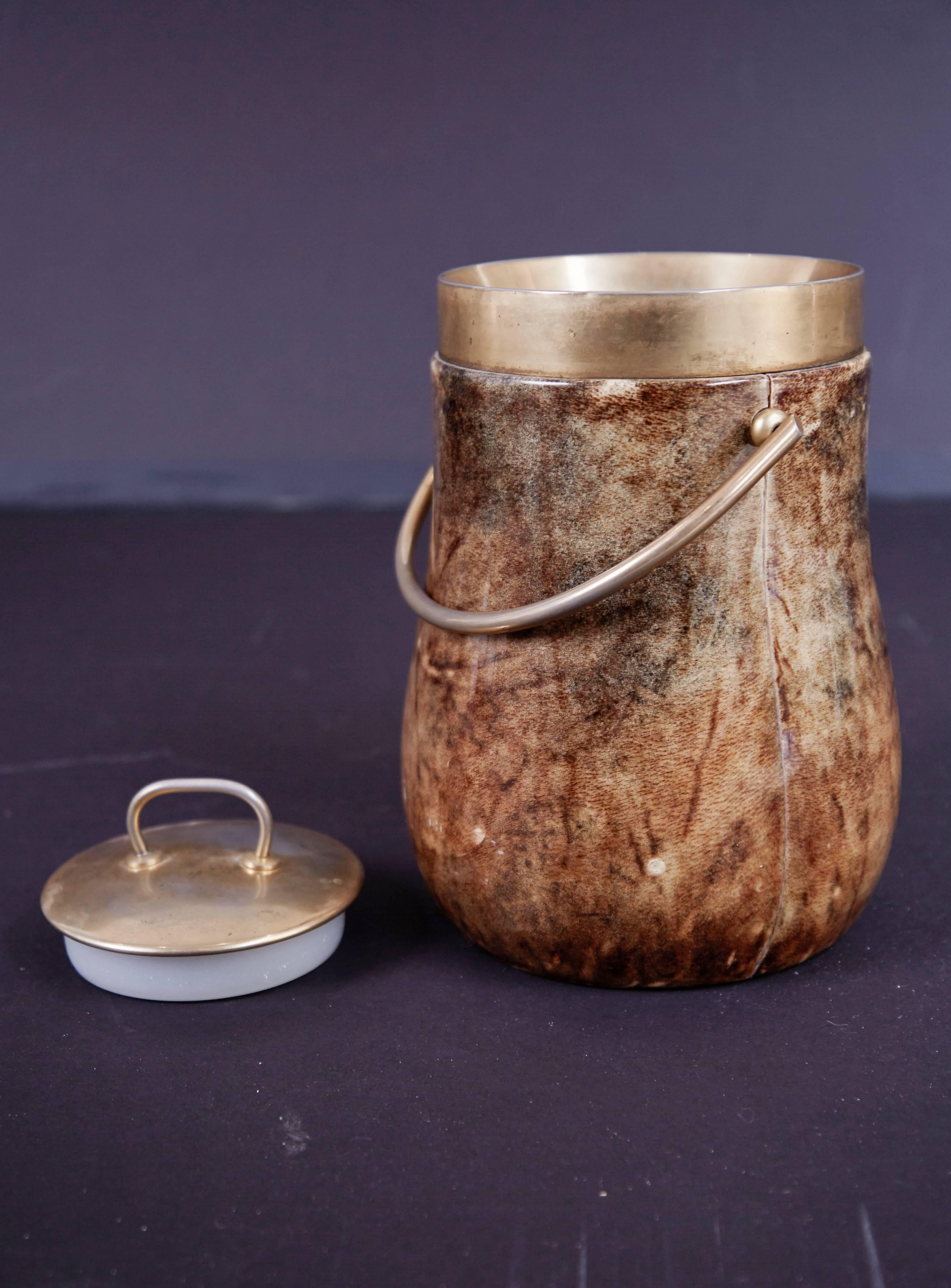 Beautiful ice bucket by Italian artist-craftsman Aldo Tura, featuring the designers distinct use of goatskin which Tura was well known for. The quality of Tura's craftsmanship can be attributed to the fact that his work was only produced in a