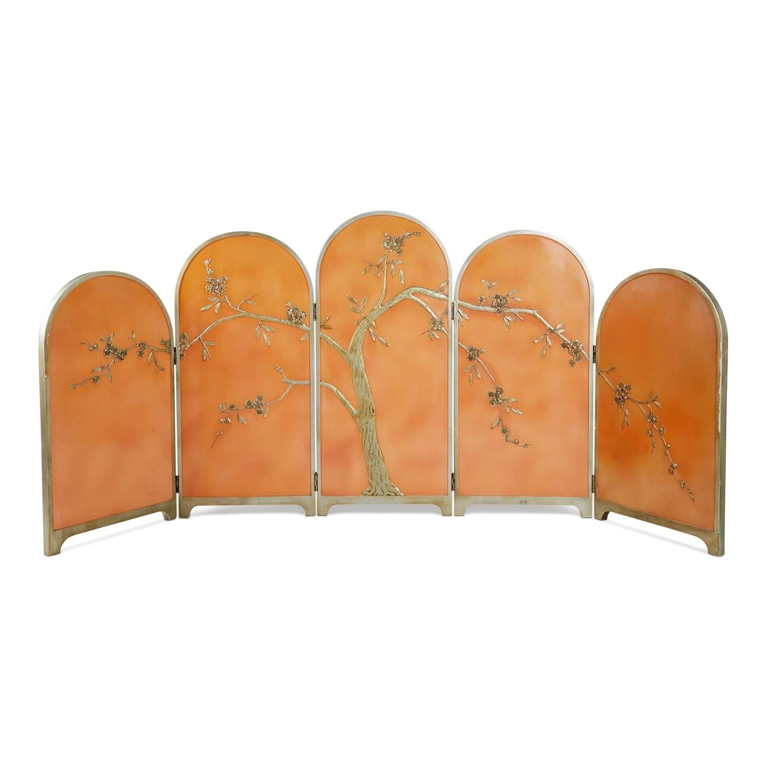 Exquisitely beautiful Art Deco chinoiserie wood folding screen with deep floral reliefs, circa 1920. This elegant room divider features a delicately carved relief blossoming tree with slender leaves and a subtly twisting trunk with a knot. The