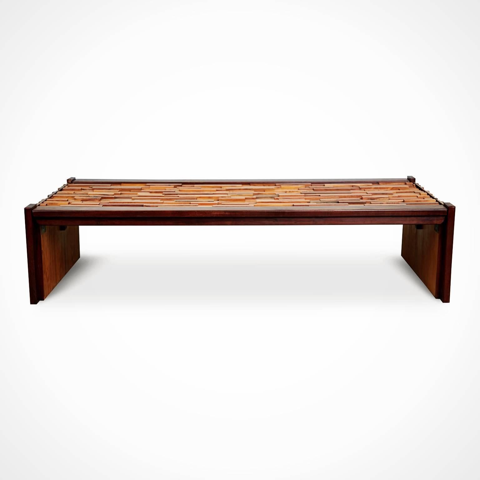 Expertly executed coffee table by Percival Lafer for L'Atelier De Sao Paulo, Brazil. This beautiful cocktail table is fabricated from Jacaranda Rosewood and Teak featuring a waterfall design which is decorated with a Brutalist style surface made up