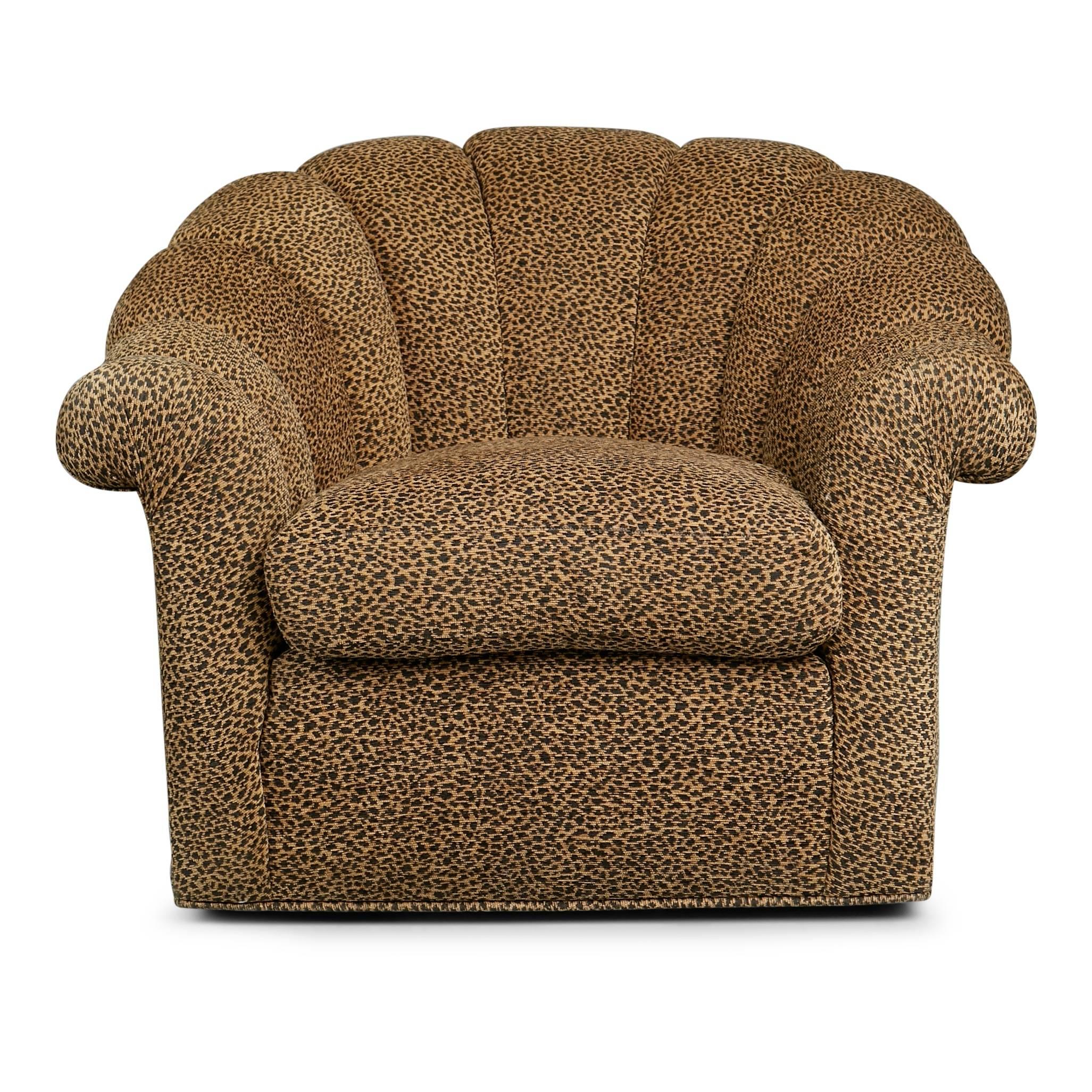 Pair of generously proportioned Art Deco style swivel chairs. These club chairs feature sculpturally flared backs and arms which have been channel tufted and upholstered in a fun leopard print chenille-like fabric. These armchairs swivel, allowing