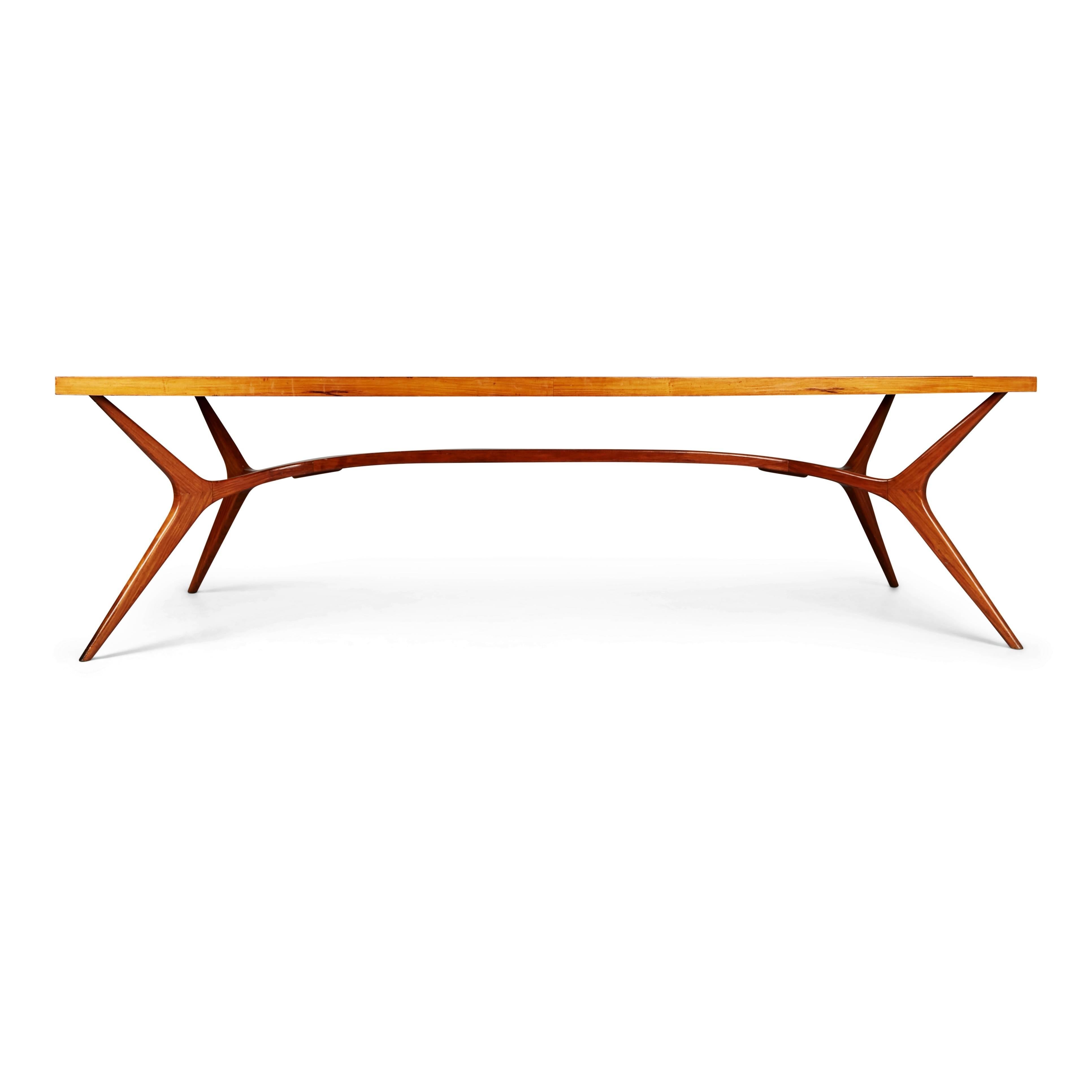Recently imported from a private collector in Brazil, this extraordinary dining table embodies the use of curvaceous lines and soft shapes that Scapinelli was well known for. Featuring a solid Peroba de Campos base supporting a vast inset glass top