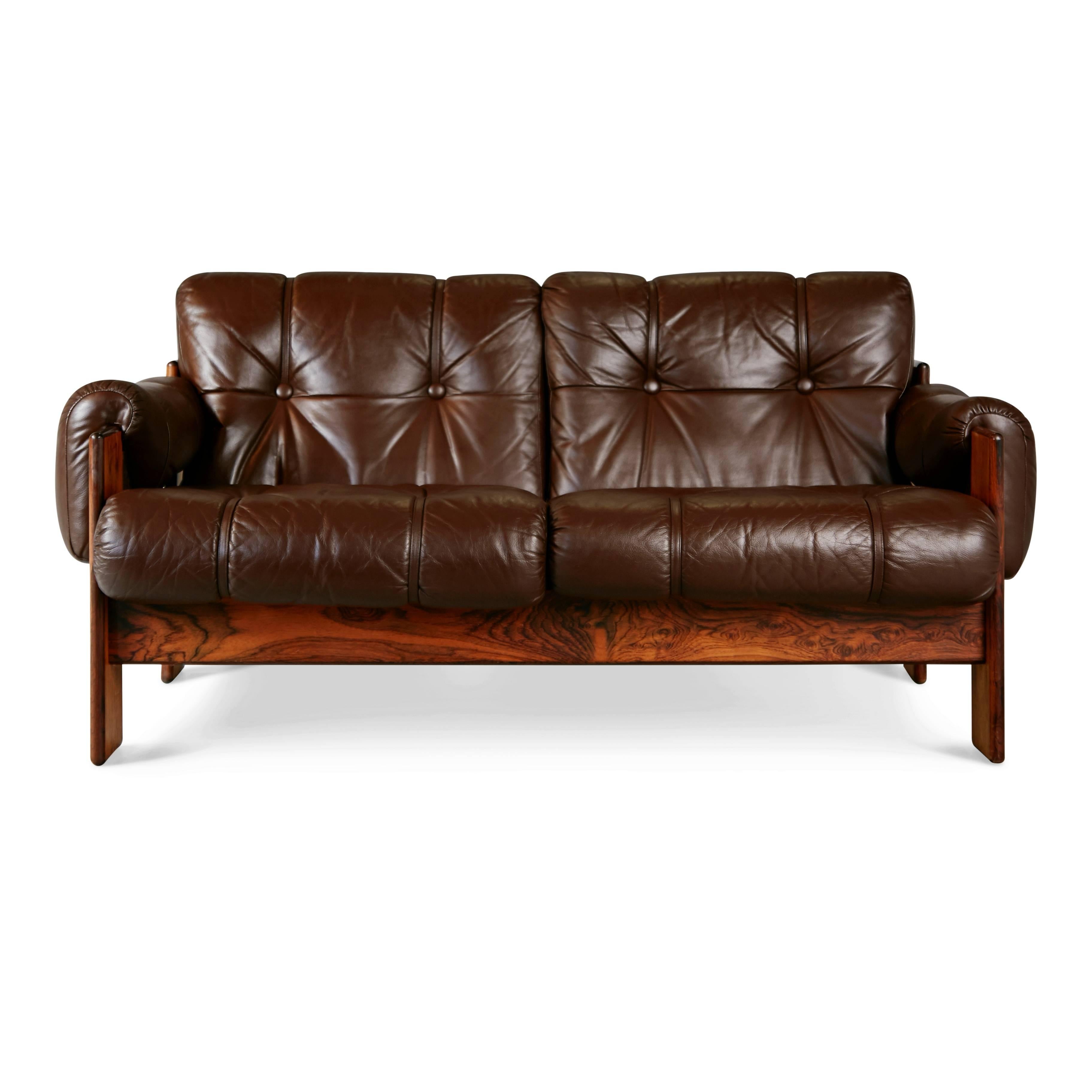 Wonderful loveseat by Kalustekiila, Finland. Featuring the original high quality tufted leather upholstery which has expertly cleaned and conditioned to the original rich brown color while still retaining the vibrant look of vintage leather. The