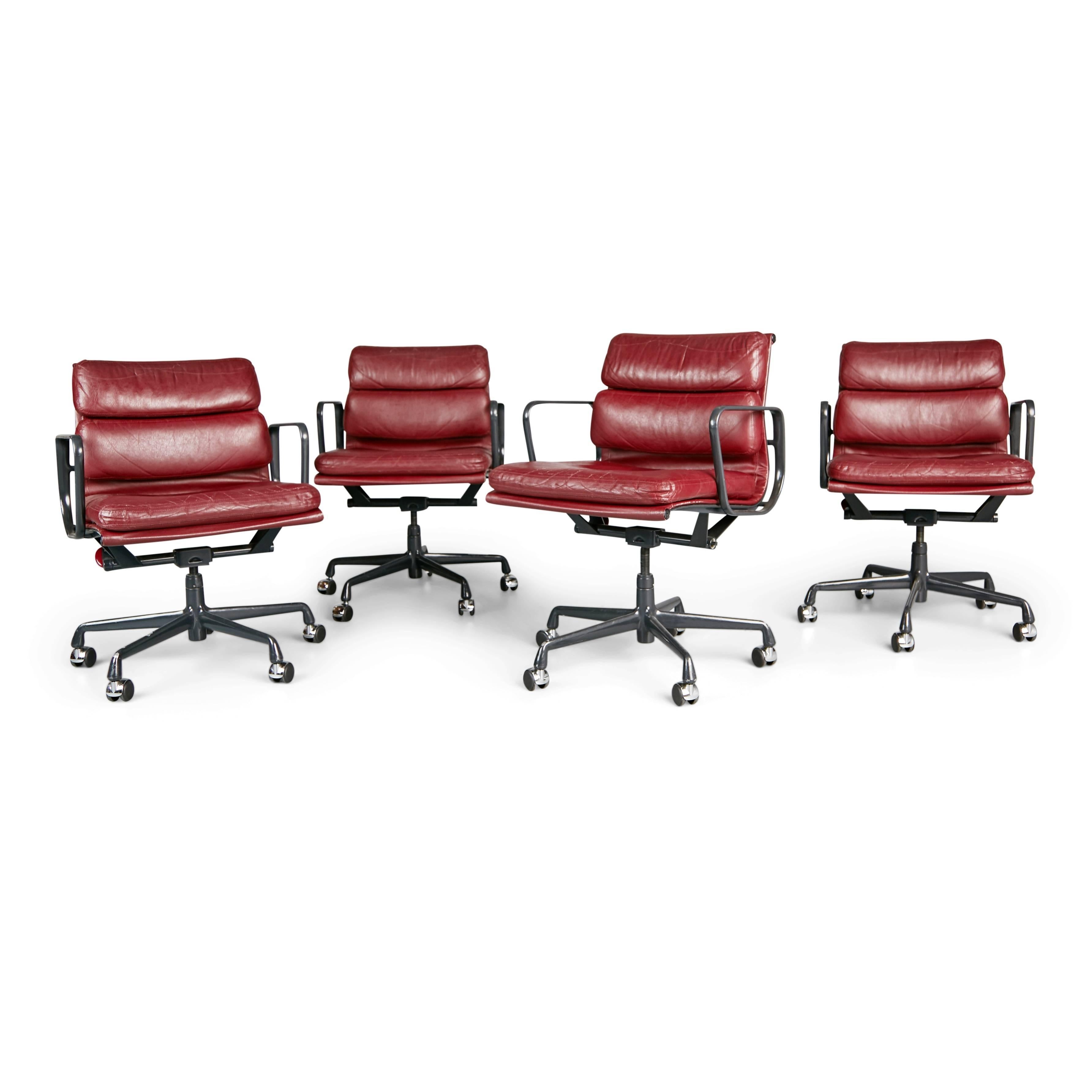 We have three left from this set of renown Soft Pad Aluminum Group Management desk chairs available designed by Charles and Ray Eames for Herman Miller. Priced individually. Featuring the original vintage rich burgundy leather upholstery over dark