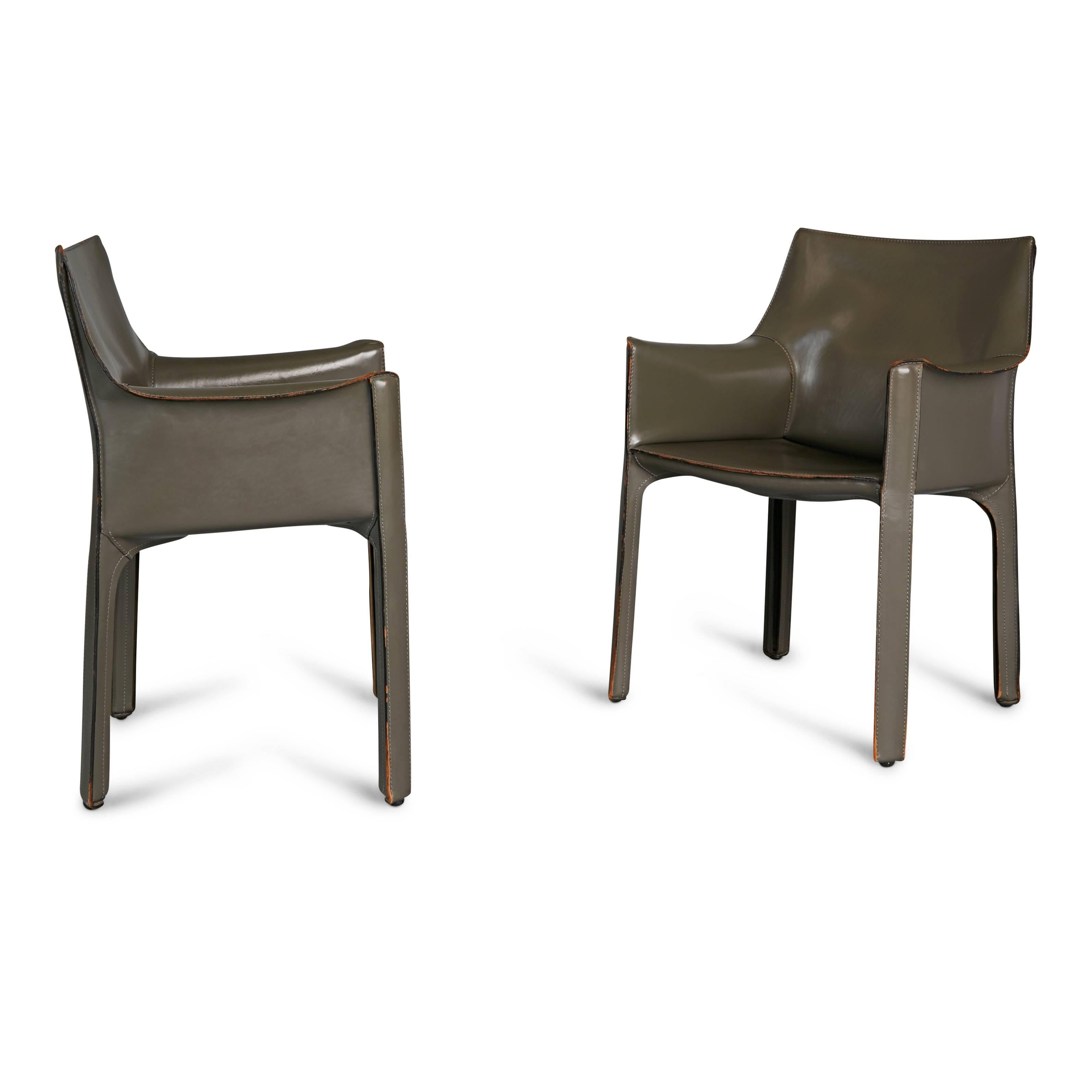 A rarer grey colored pair of Cab chairs designed by Mario Bellini for Cassina, with beautiful patina to the high-quality Italian leather. Originally conceived in 1977 these armchairs are comprised of enameled steel frames, padded with polyurethane