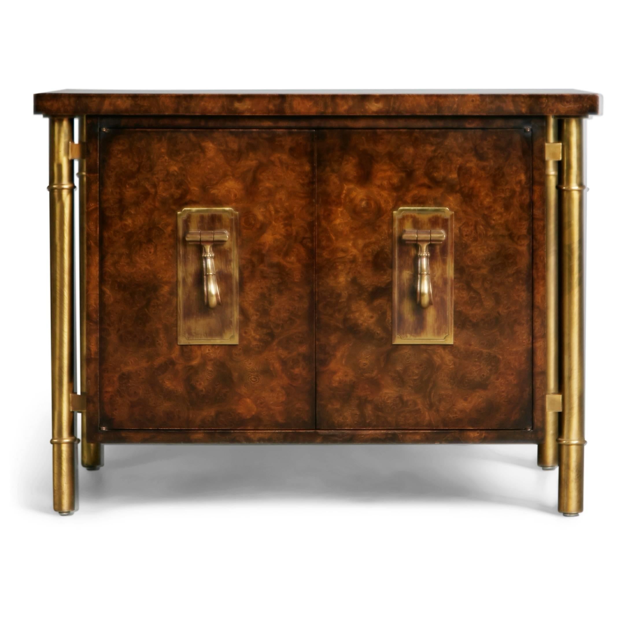 This Asian inspired Mastercraft side table / end table / nightstand / small cabinet piece by William Doezema for Mastercraft features a burl wood finish with brass cylindrical legs running the length of the cabinet from under the top down to the