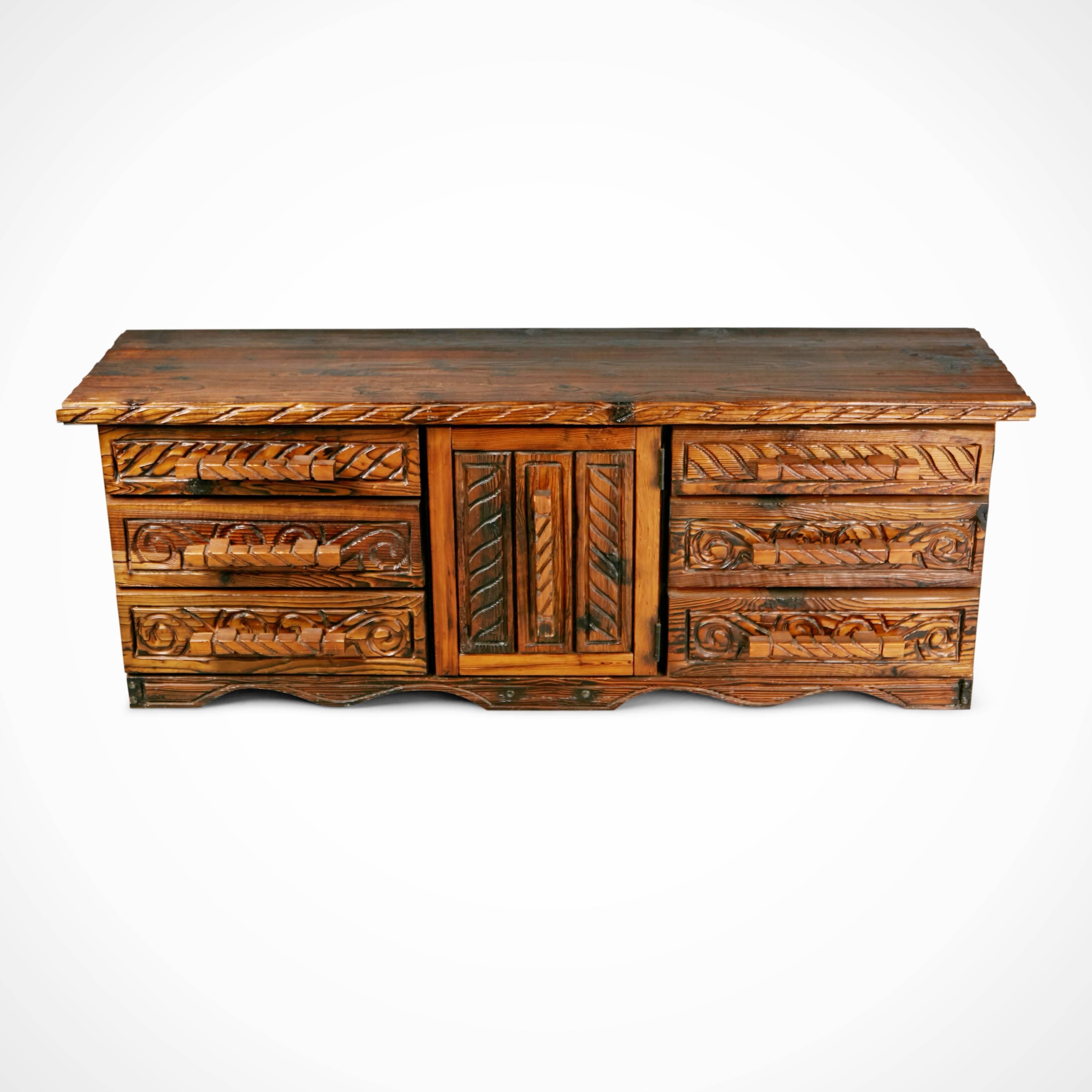 This ornately crafted walnut credenza, sideboard or dresser with carved exotic details is a testament to William Westenhaver's Modern Primitive creations. Influenced by Polynesian natives sculpting their ancestral deities in to wood furnishings,