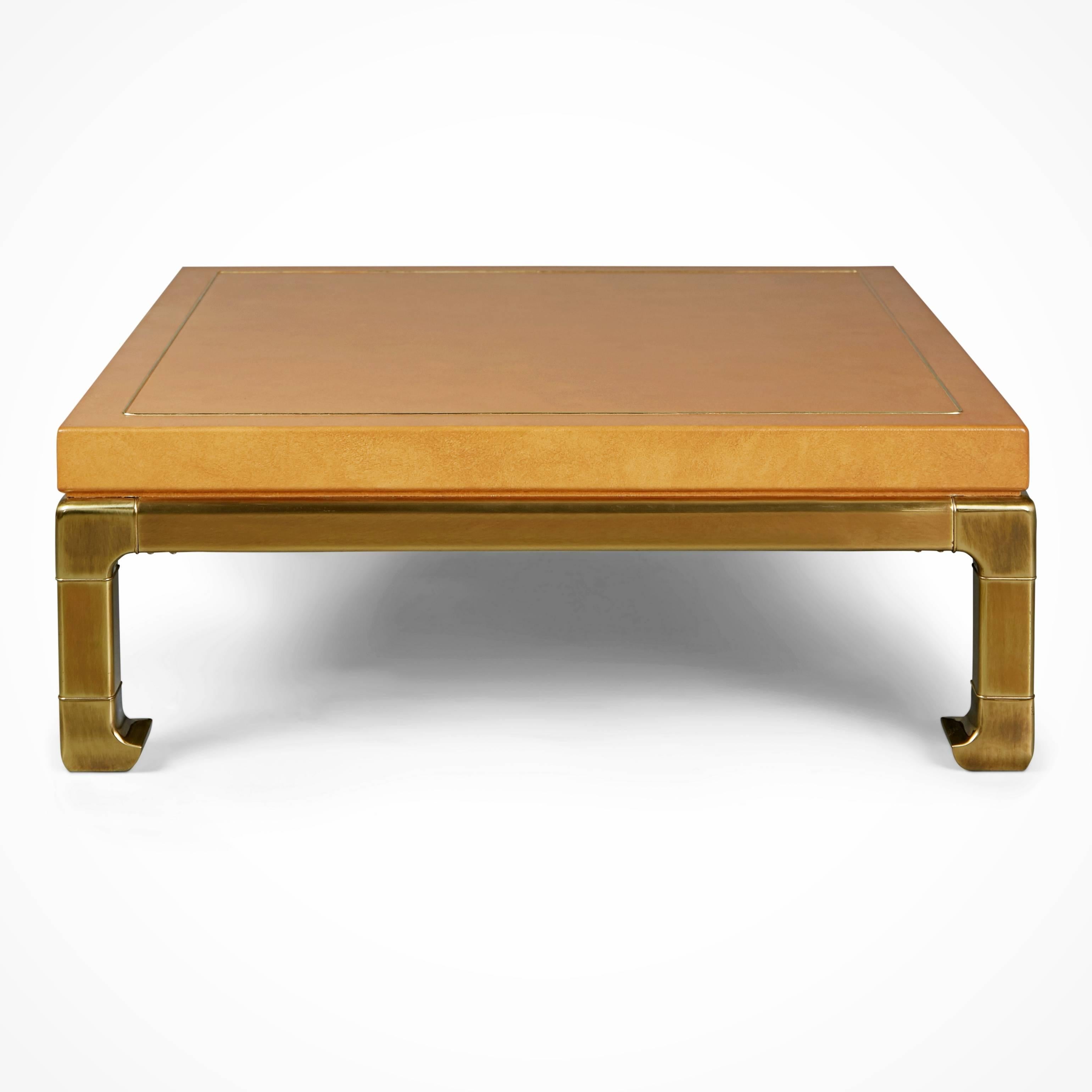 Exquisite custom ordered expansively proportioned square coffee table and rectangular side shaped side table from Mastercraft. These gorgeous pieces feature lacquered faux ostrich skin tops over wood with brass borders and luminescent on-trend heavy