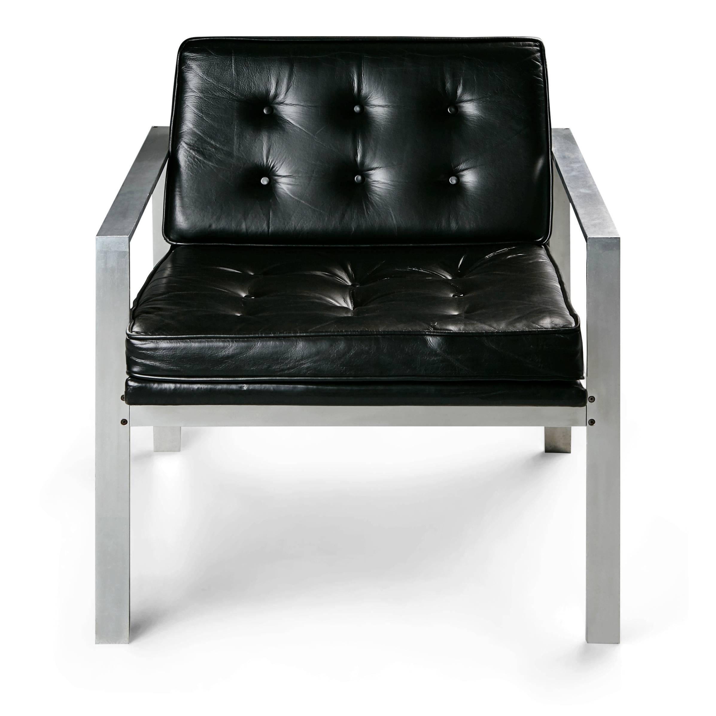 Rare and collectible pair of aluminum armchairs by Harvey Probber, featuring tufted high quality classic black leather upholstered seat cushions and seat back cushions with solid aluminum frames of modern form. These are the authentic Probber chairs