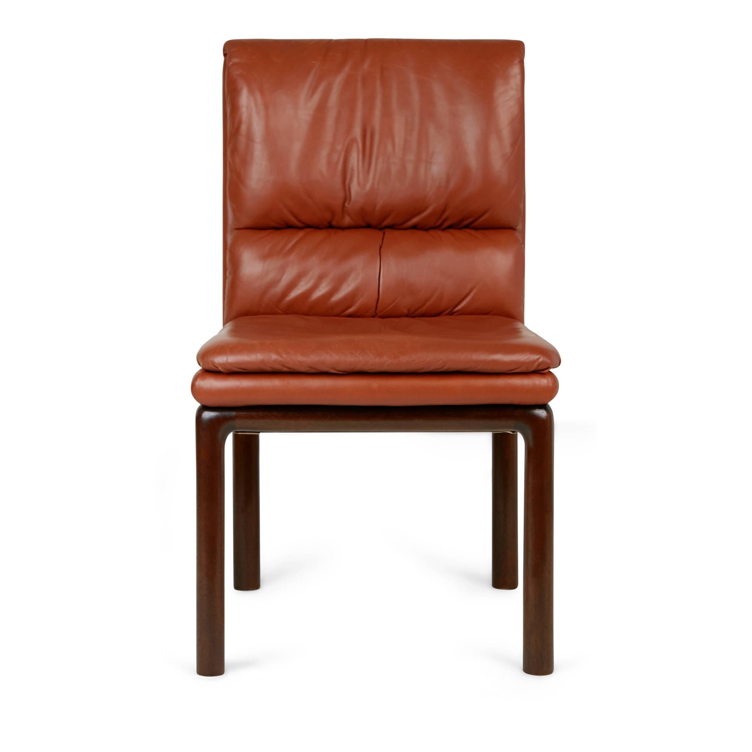 Handsome Edward Wormley side chair for Dunbar. This minimally designed occasional chair is upholstered in a rich medium toned brown leather with subtle ruched details on the backrest. The legs have been fabricated from mahogany and contrast