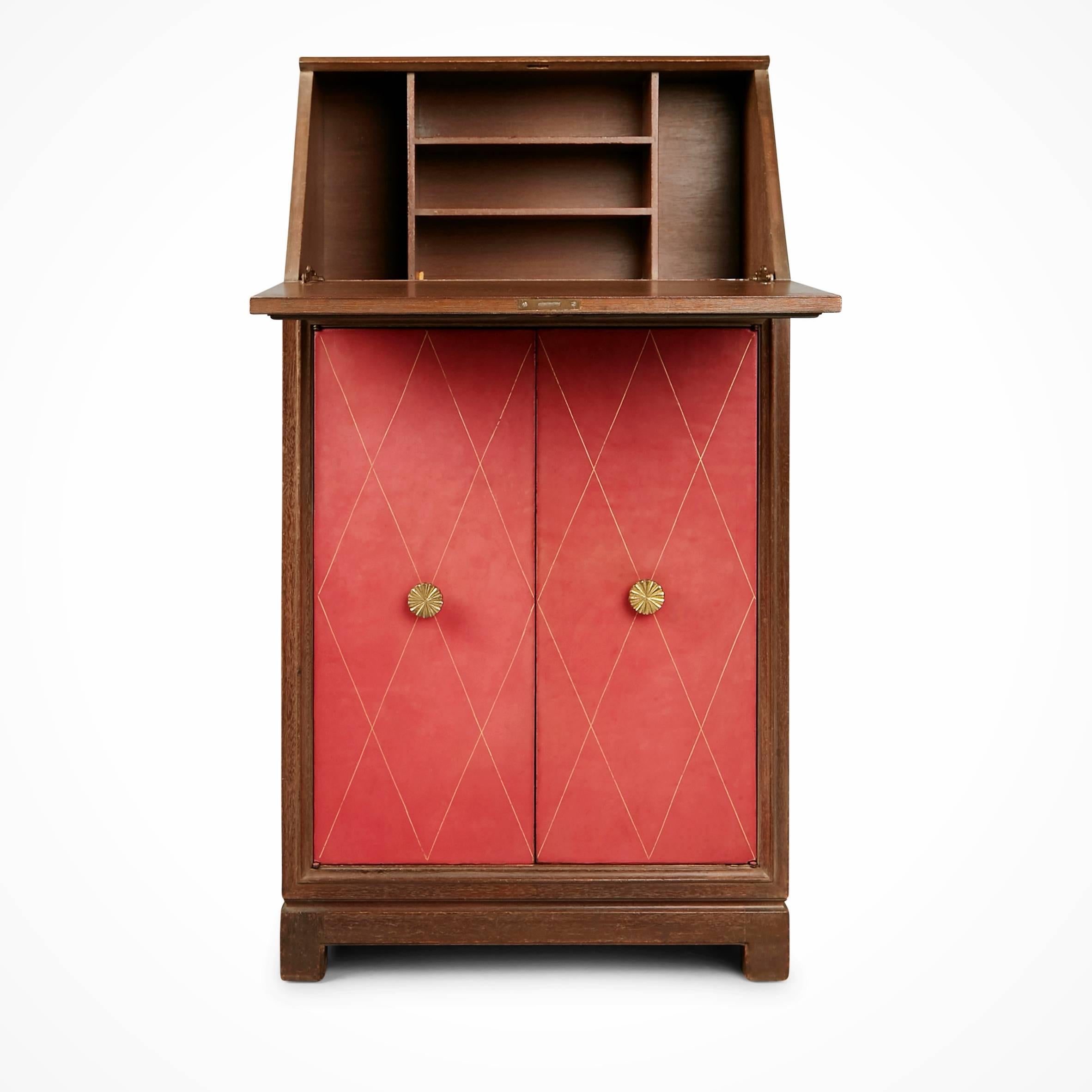 Exquisitely designed secretary bureau by Tommi Parzinger for Charak Modern. This elegantly executed piece is fabricated from pickled mahogany with tooled leather in a color that falls somewhere between pink and rose cupboard doors punctuated by