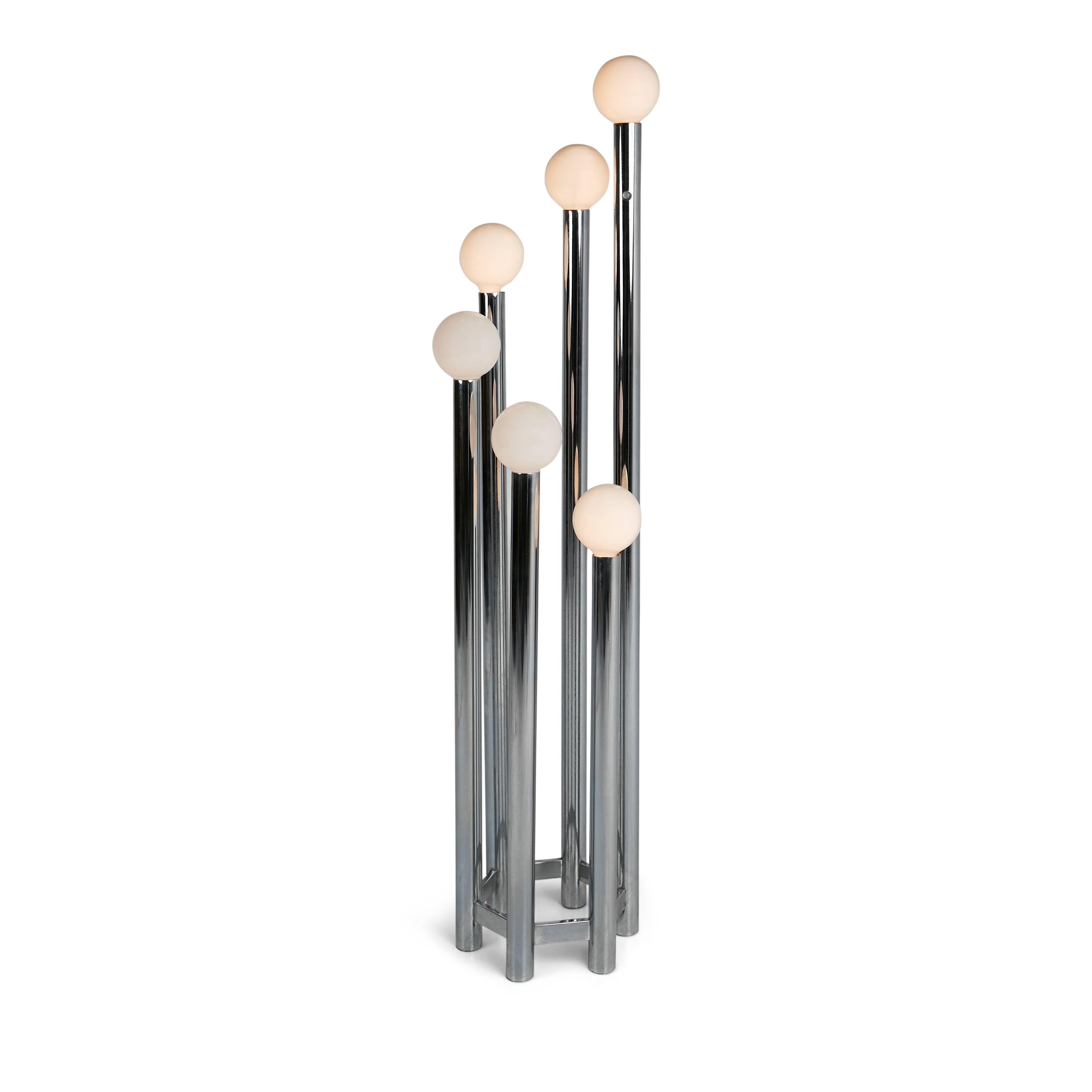 Sculpturally designed torchiere floor lamp, circa 1970. This sleekly constructed standing lamp consists of six chrome rods which gently escalate in height to create a visually pleasing composition. The lamp is topped with globe shaped bulbs which