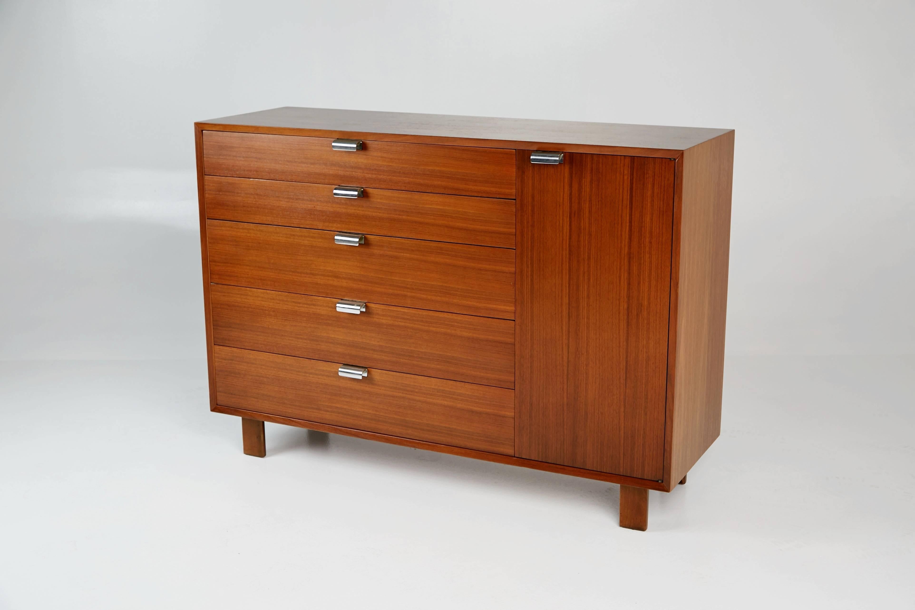 Designed by George Nelson, this dresser or credenza was part of Herman Miller's collection of modular basic storage components. The chest has been newly refinished and features beautiful wood grain which displays fluid movement and variation in