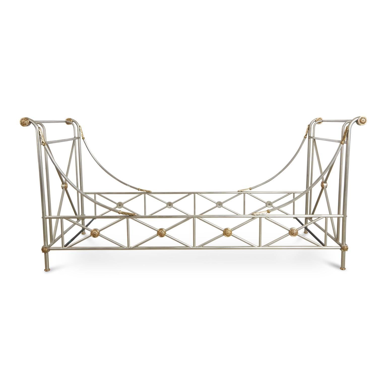 Gleaming Maison Jansen brushed nickel daybed with beautiful brass accents. Featuring an elegantly constructed frame with swooping side rails and elevated identical head and foot boards and punctuated with brass medallions as well as arched acanthus