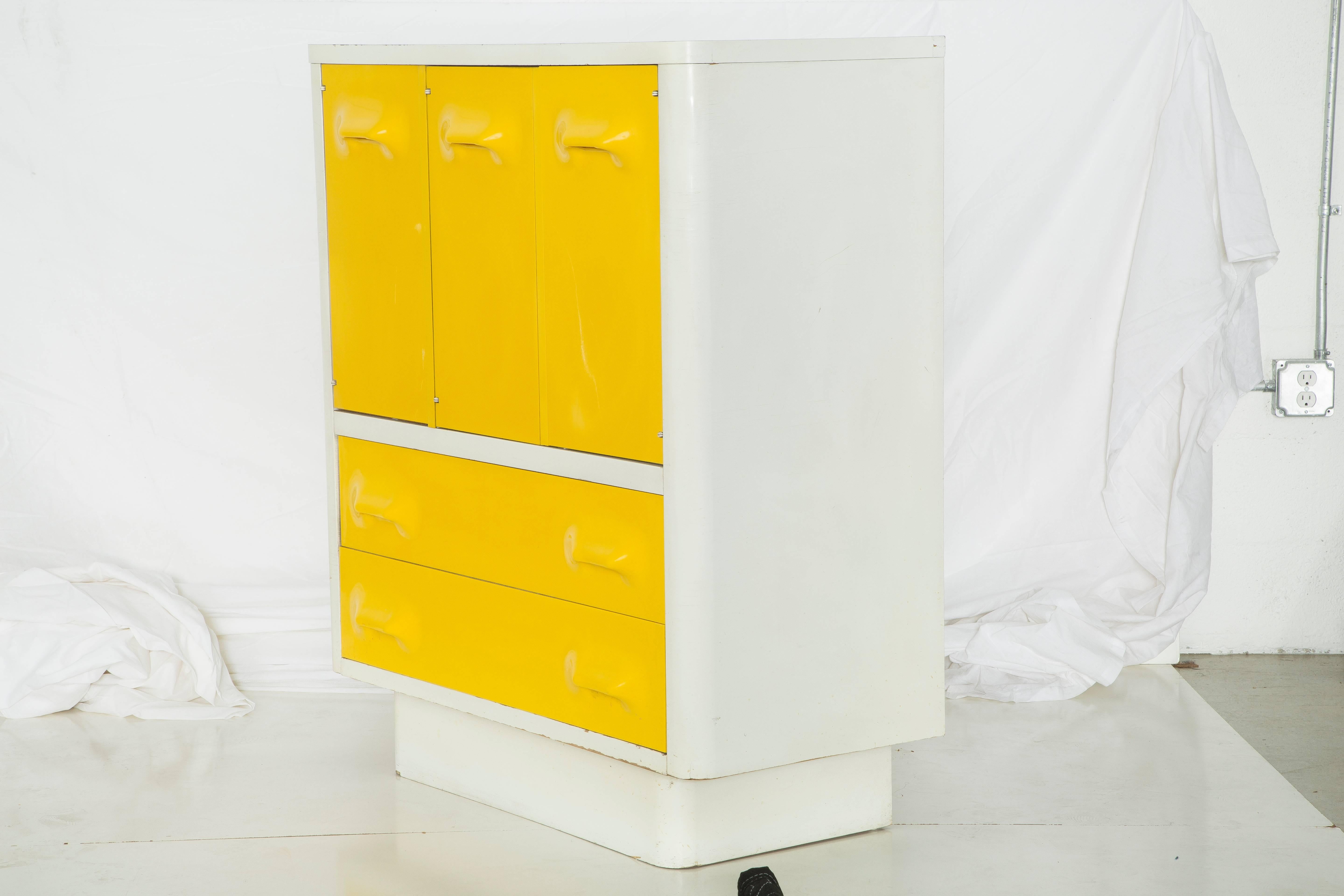 White and yellow Broyhill Chapter One Series dresser in the style of Raymond Loewy Mod-Pop Industrial Design, circa 1970s. The white body of the credenza is lacquered wood, and the vibrant yellow drawers are molded plastic. Three top cabinet doors -