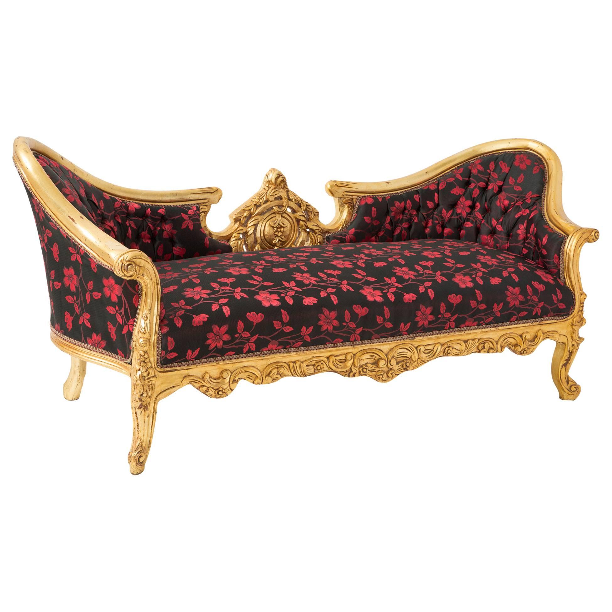 Ornately carved gold frame with decorative black and red floral upholstery.

MARKED DOWN FROM $2,499.00