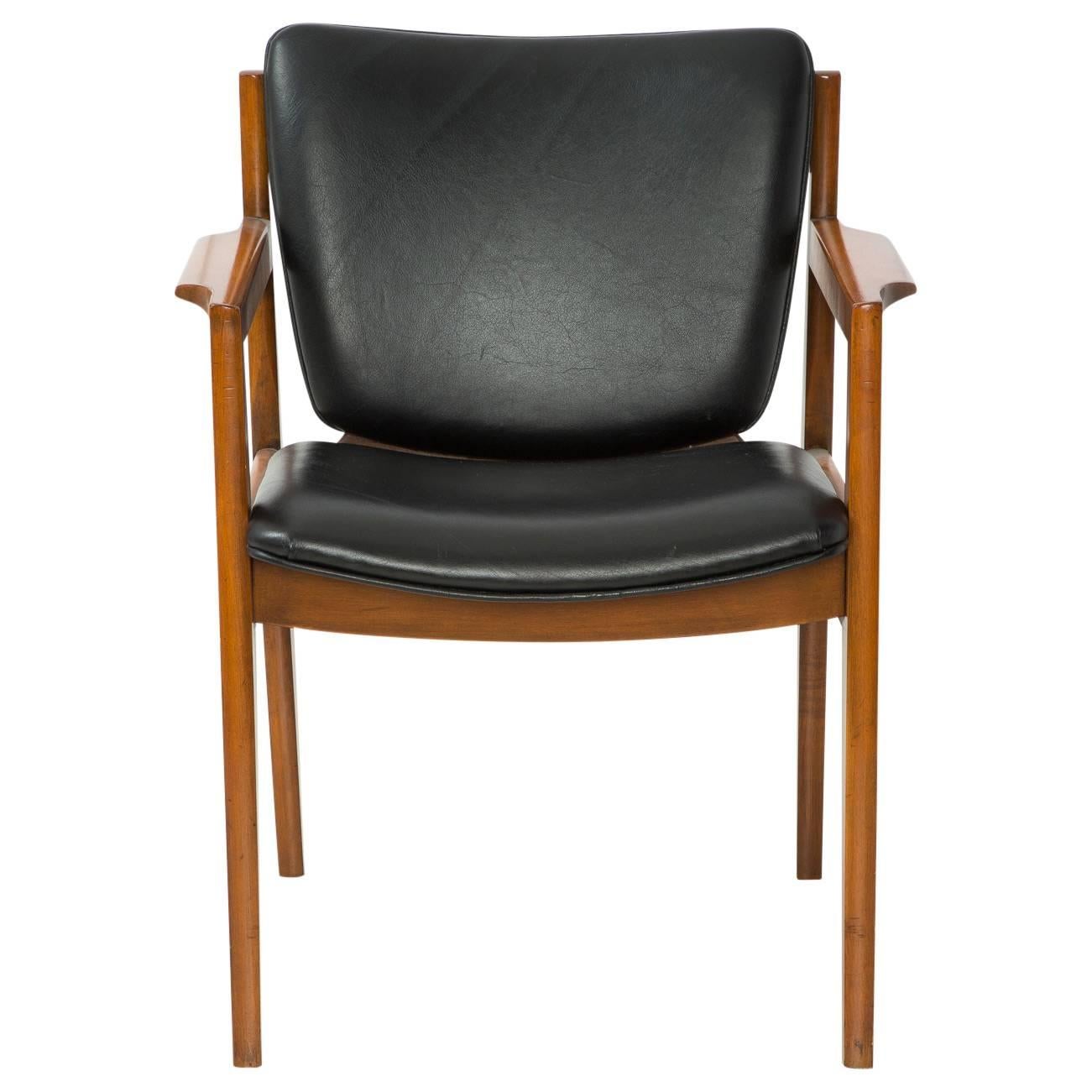 The perfect Danish modern armchair for your study, living room, or anywhere in your home. The leather and wood are in fantastic vintage condition.