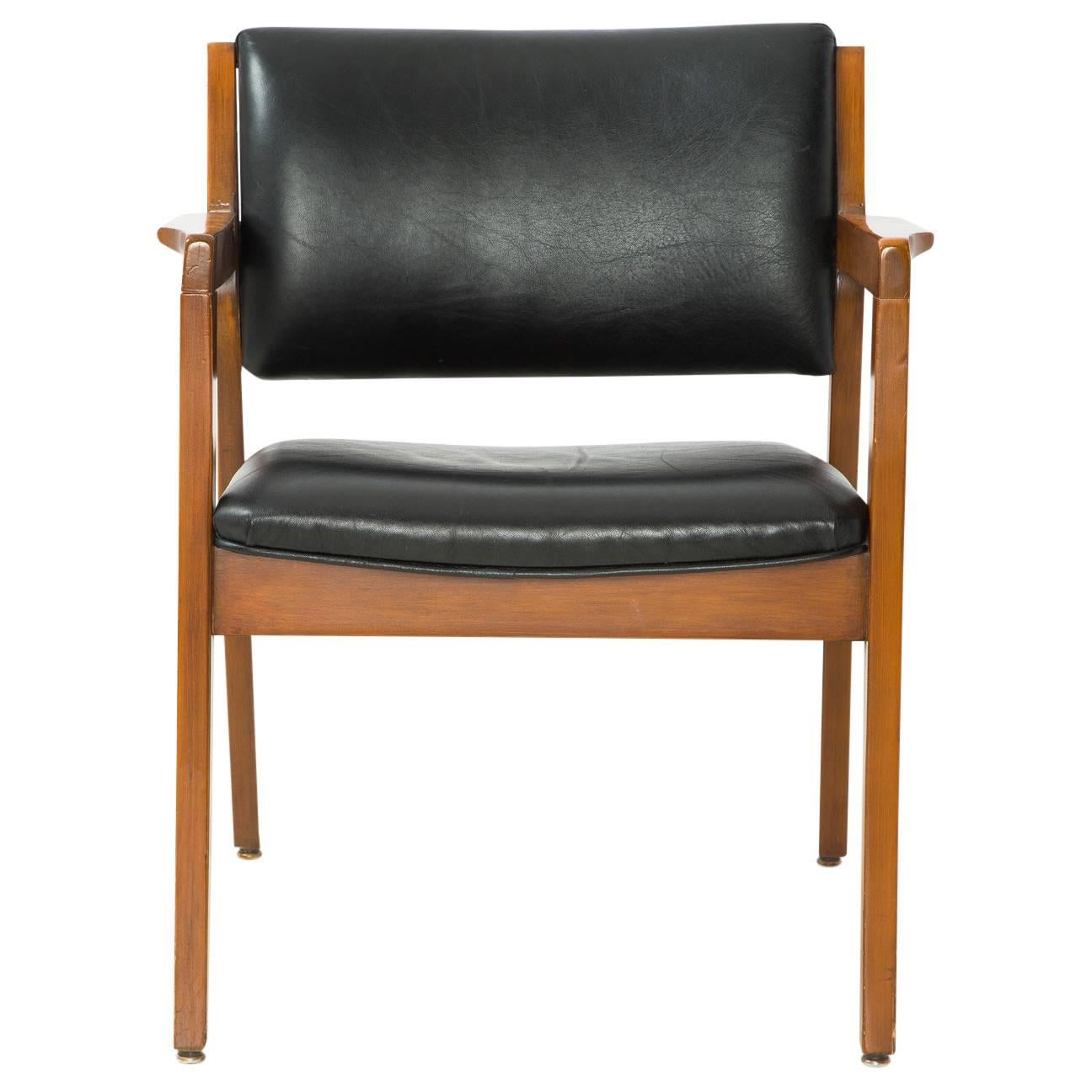 Great Danish modern armchair in the style of Finn Juhl with black leather upholstery on the seat and backrest. Fantastic condition and perfect for a study, dining room, living room, or any room. Great use for an occasional chair, a bedroom bedside