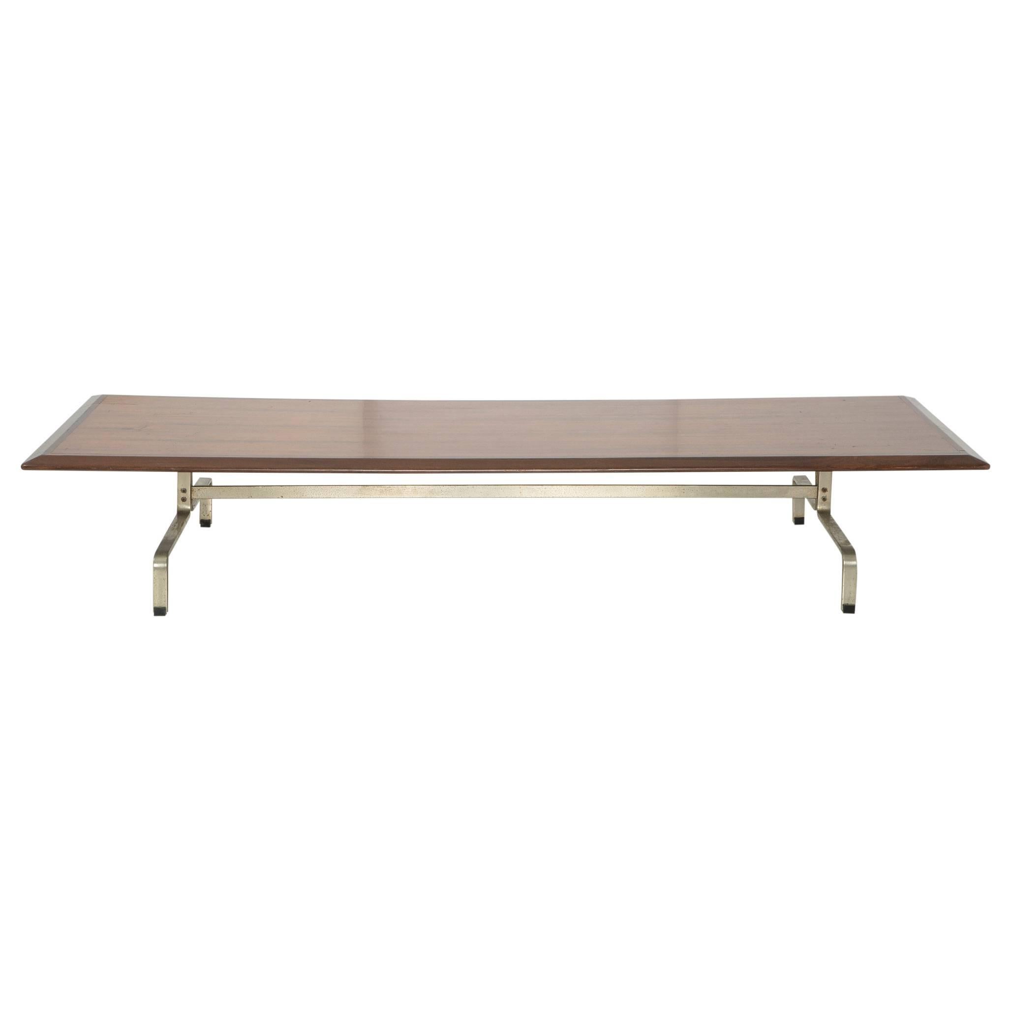 This long and sleek coffee table has an identical and indistinguishable base that matches the PK-31 series by Poul Kjaerholm for E. Kold Christensen. While we have never seen another example of this coffee table, it is possible that this was a