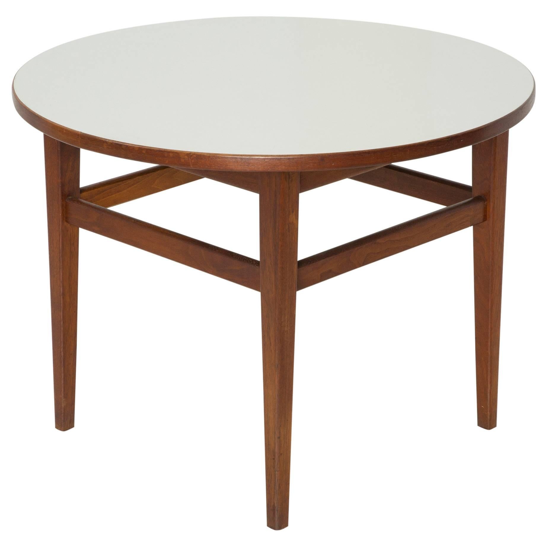 Lovely circular side table constructed of wood with white laminate top. In the style of Jens Risom. Can be used as a side, coffee, or occasional table.  

In excellent condition with light wear commensurate with age and use.  Contact us for a full