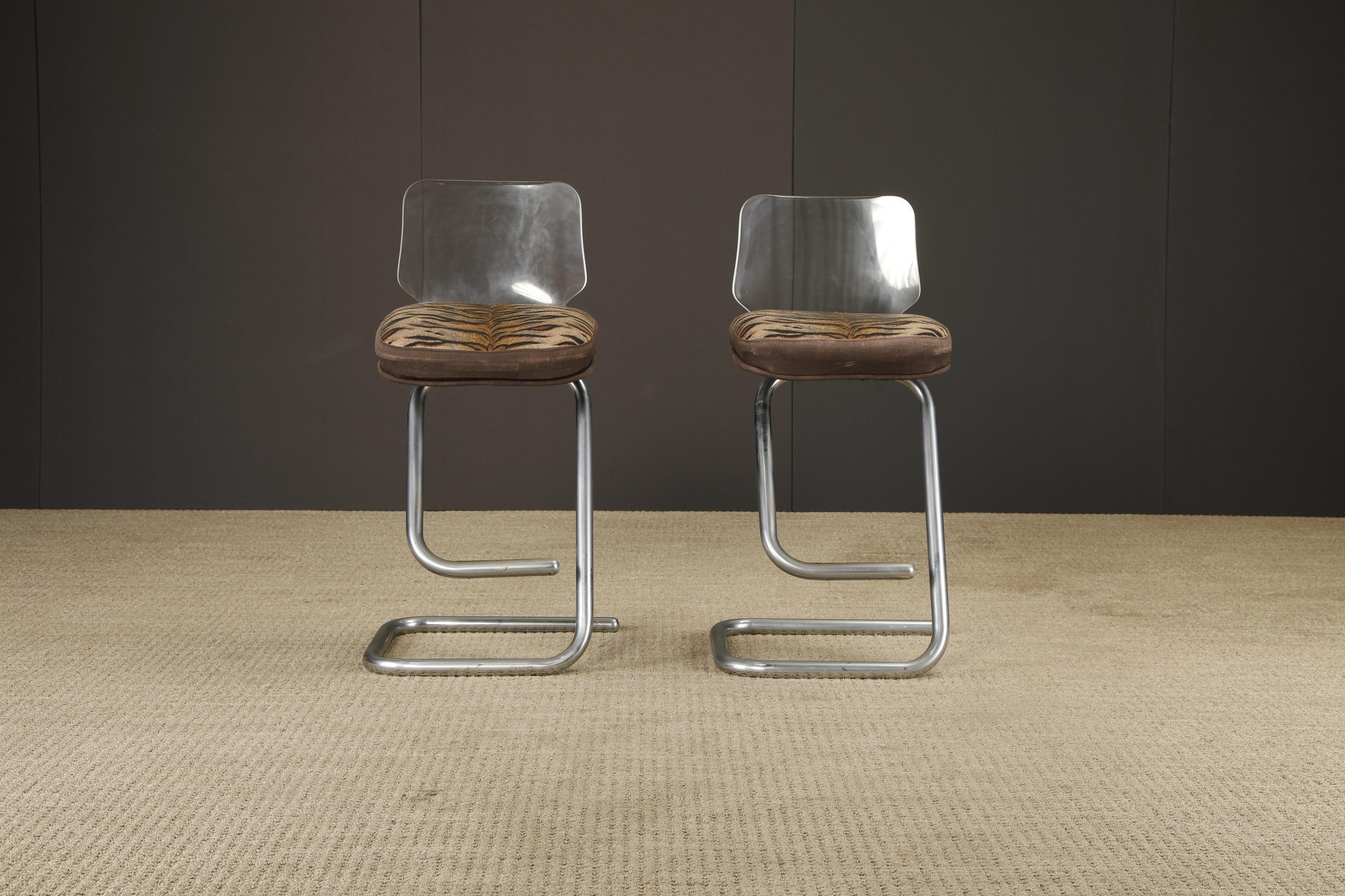 Playful, sculptural, and unmistakably bold, this pair of Italian cantilever barstools by Luigi Bardini, designed in the 1970s for Miniforms Design. Each stool features a gracefully curved chrome tubular frame, paired with a faceted Lucite backrest