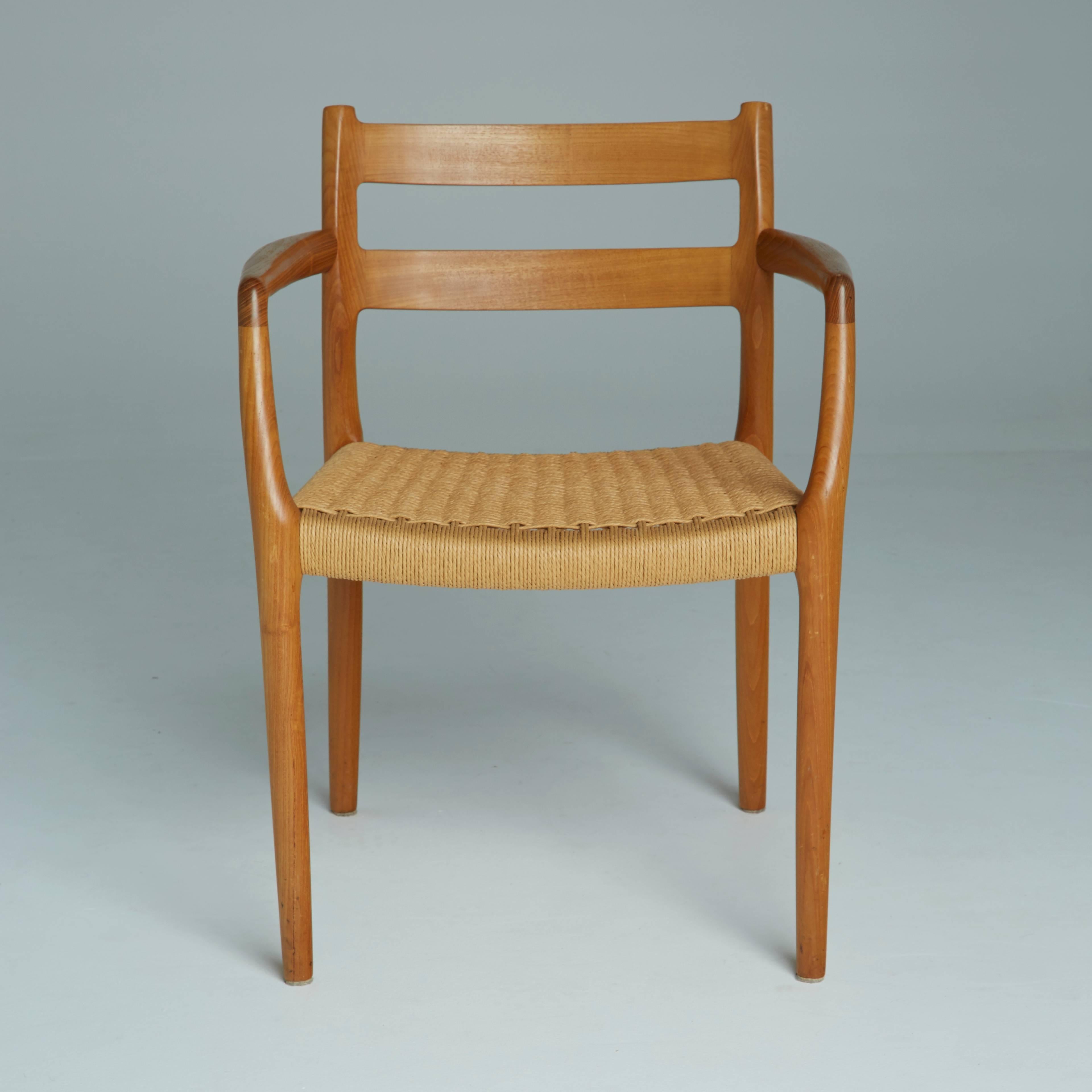 These Danish modern model 67 chairs, designed by Niels O. Møller, are one of J.L. Møller's landmark designs. The teak frames feature two curved support strips across the backrest, two sculptural arm rests, and an original woven cord seat. 

In