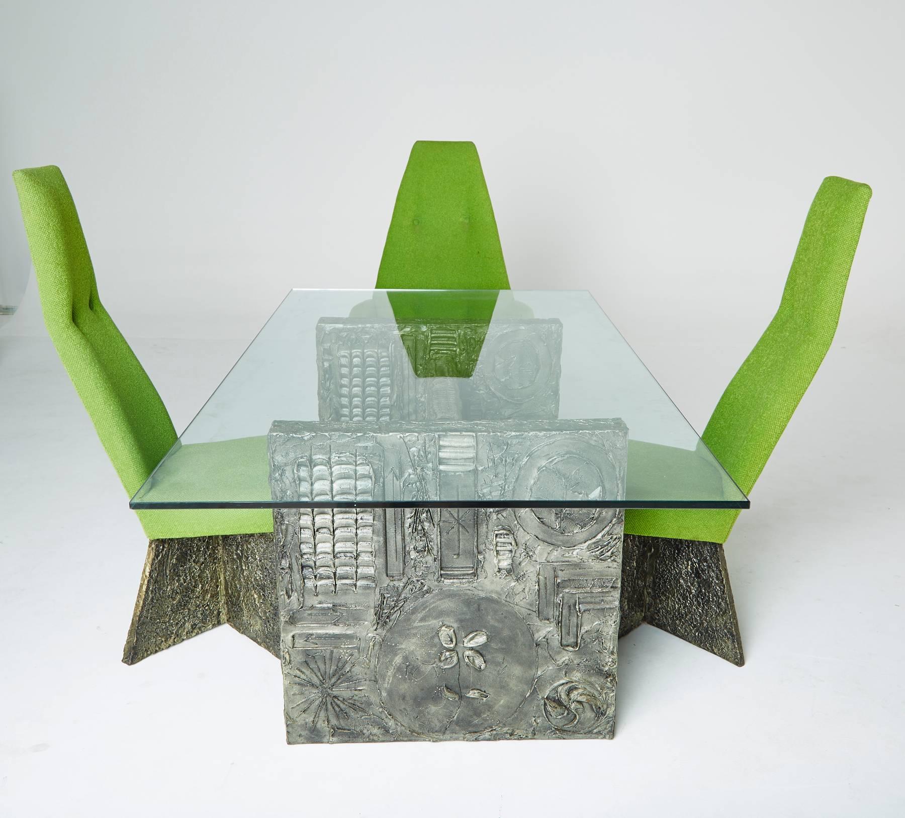 Designed by Adrian Pearsall for Craft Associates, in the style of Paul Evans, this Brutalist dining set is wildly unique, with four chairs (two armchairs and two side chairs) with its matching glass top dining table.

The Brutalist table legs are