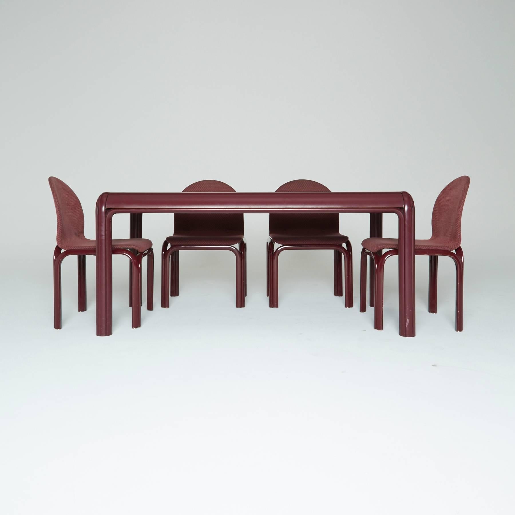 Created by one of the few female members of the postwar Italian modern movement, Gae Aulenti for Knoll International, circa 1970. This complete burgundy dining set is quite a rare find.

The frames of the six chairs are constructed by sculpted