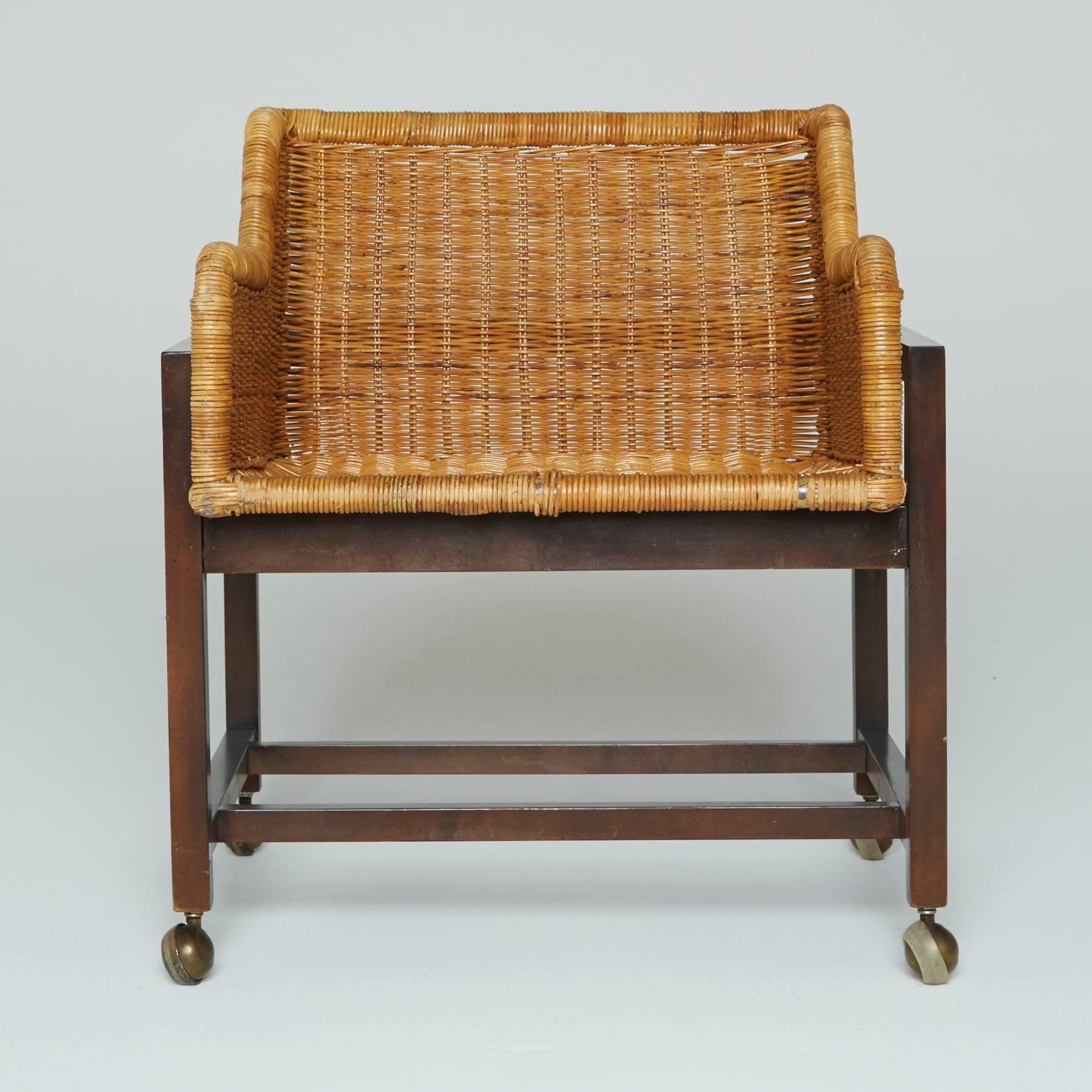Squared seats made of woven wicker with curvaceous arm rests, displayed by their dark wooden frames and capped with four brass casters. Perfect for both indoor use and outdoor patios, these armchairs fall in line with many relevant styles, from