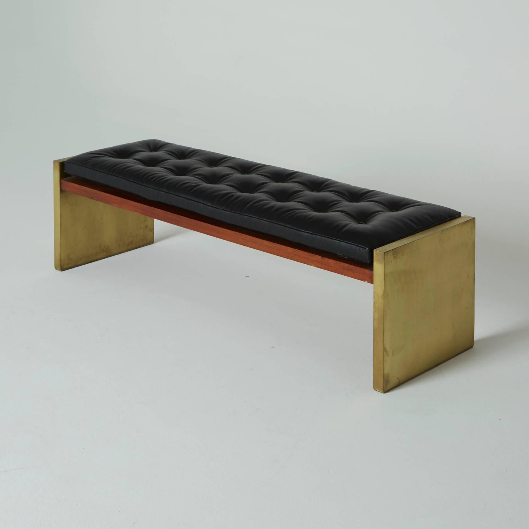 Rarely constructed with a brass frame, this Roger Sprunger window bench is a truly coveted gem. Large enough to comfortably seat three or one for an afternoon nap.

Sitting atop the rosewood bench is a black leather cushion by Edelman.