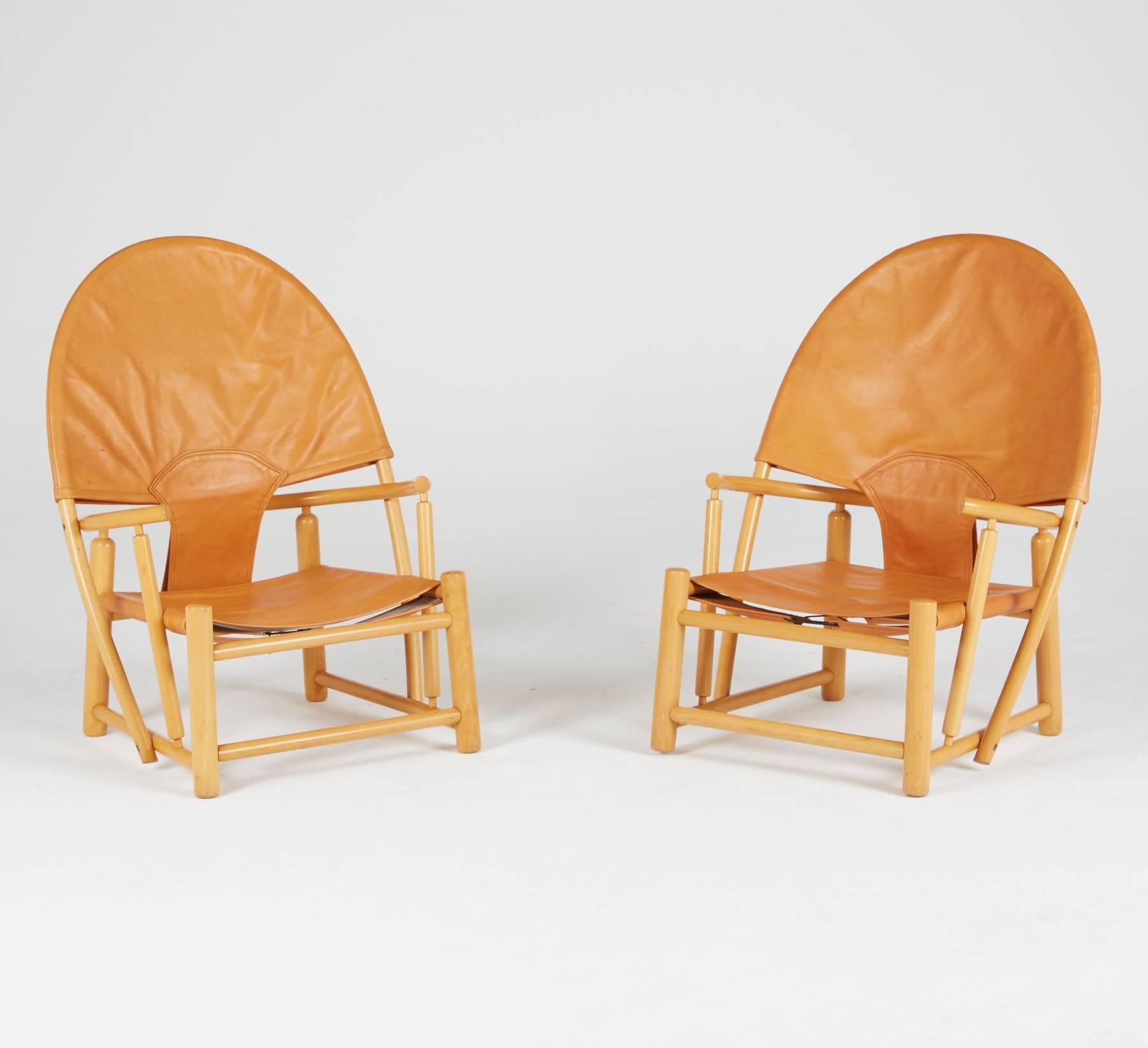 Our favorite color-way for this unique and rare design by Piero Palange and Werther Toffoloni - and best of all we have a matching pair. 

The tan leather sling and backrest have a slight orangy tint and sitting atop the beech frames - this