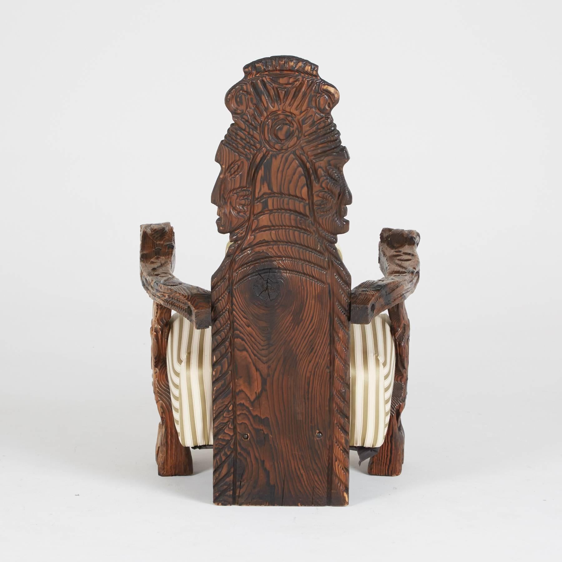 
Sit tall and regal on a piece of American history with this exotic throne, crafted in true Modern primitive style. Deep, red walnut is turned into a work of art, with carved details on the arms and back depicting Polynesian deities.

William
