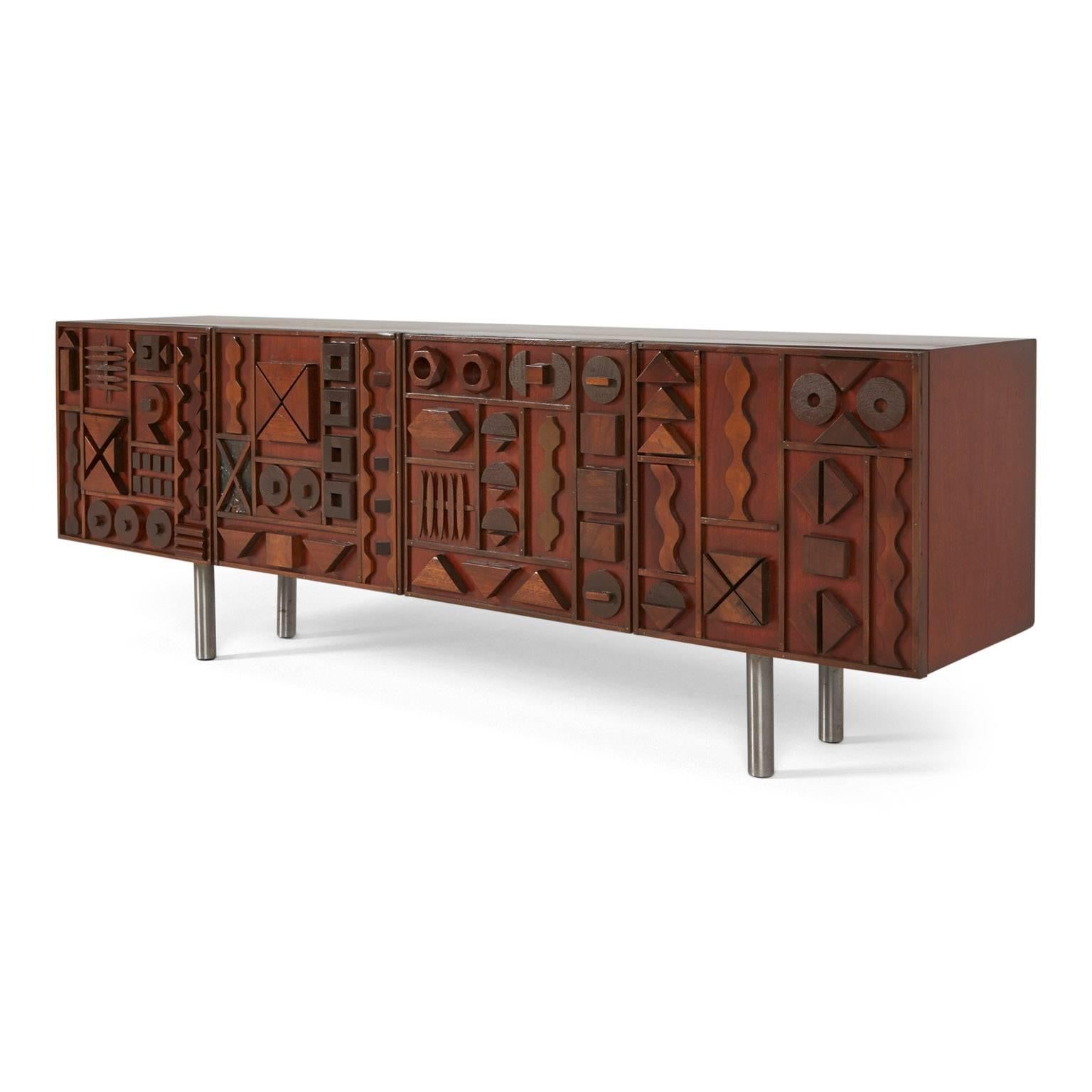 Custom handcrafted Brutalist credenza designed and crafted by Lou Ramirez. Embossed with emblematical abstract details and finished in a manufactured patina. Illustrative of the original designs of the Brutalist era, inspired by Mabel Hutchinson and