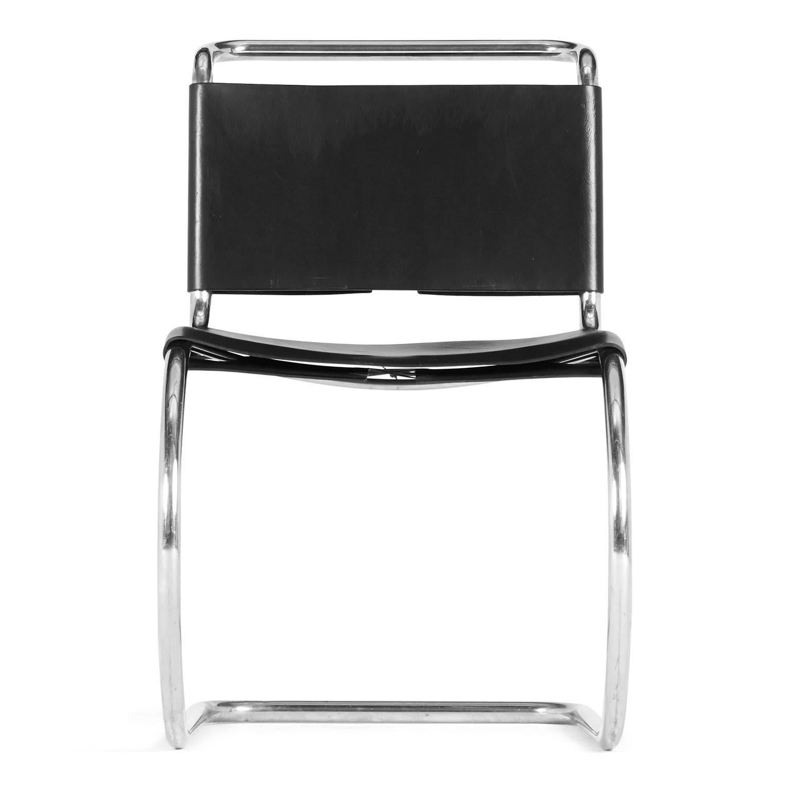 Designed by Ludwig Mies van der Rohe for Knoll International, this black leather side chair with laced up back and seat detail are stamped October 12th 1979. The tubular steel frame in polished chrome facilitates a contemporary appeal. The modern