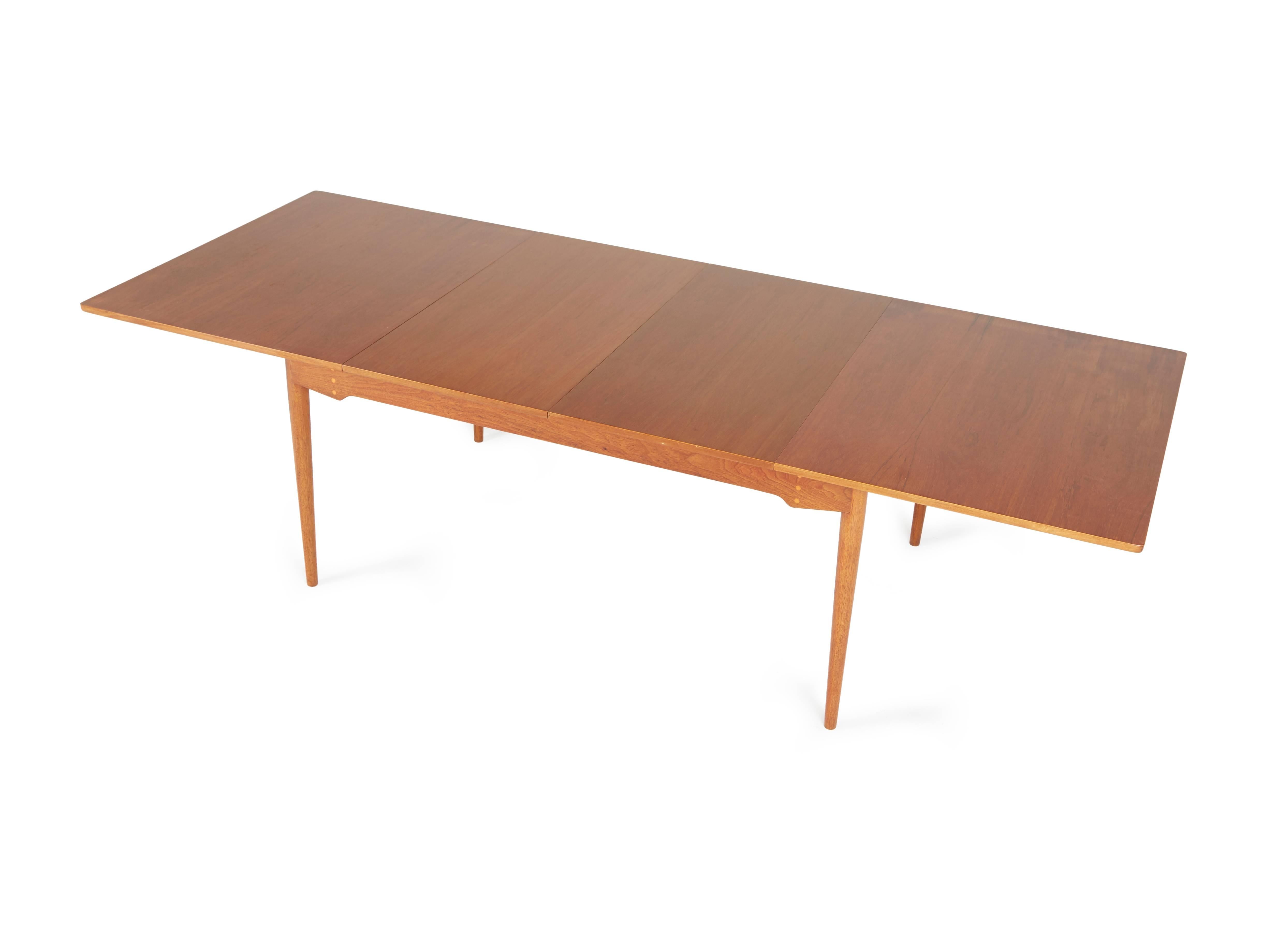 An original 1960s extendable dining table by Finn Juhl, designed for Baker Furniture. This Classic Baker / Juhl example is comprised of a solid teak frame and top. 

Complete with two 22" self-storing leaves that hide under the main tabletop,