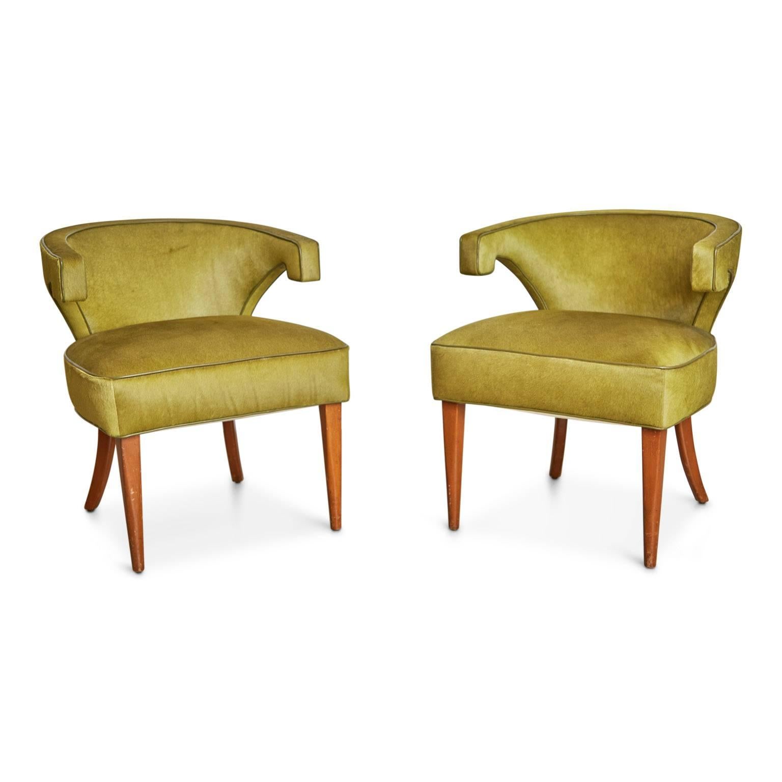 Wonderful pair of Veronese Klismos chairs by Tommi Parzinger which have been newly upholstered in a lush olive green hair-on-hide leather with color matching leather trim. The curvaceous silhouette of these armchairs with their distinct angular arms