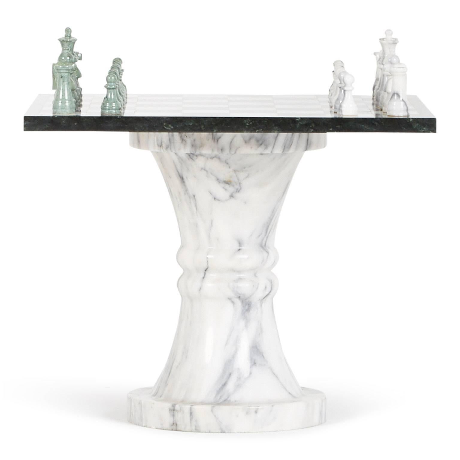 Stunning marble chess set which includes one pedestal table with removable chess board and two stools, as well as the full set of chess pieces. The fluted pedestal table and two matching stools are fabricated from solid Carrera marble and the seat