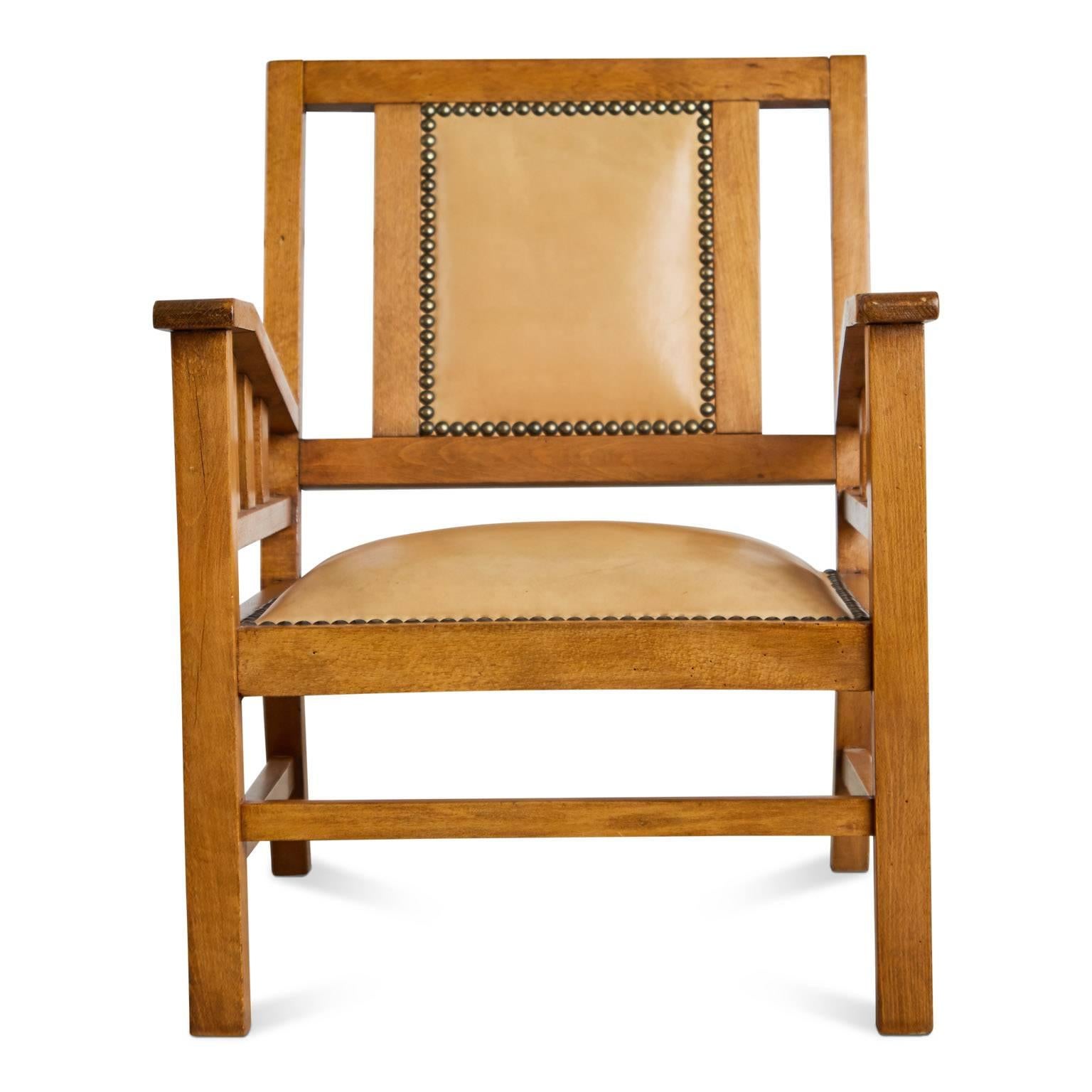 An exemplary example of Art Deco Modernist armchairs by French designer Francis Jourdain. The simple, straightforward composition is comprised of a stained beech frame with a slanted back and pale tan color upholstery as well as being finished with