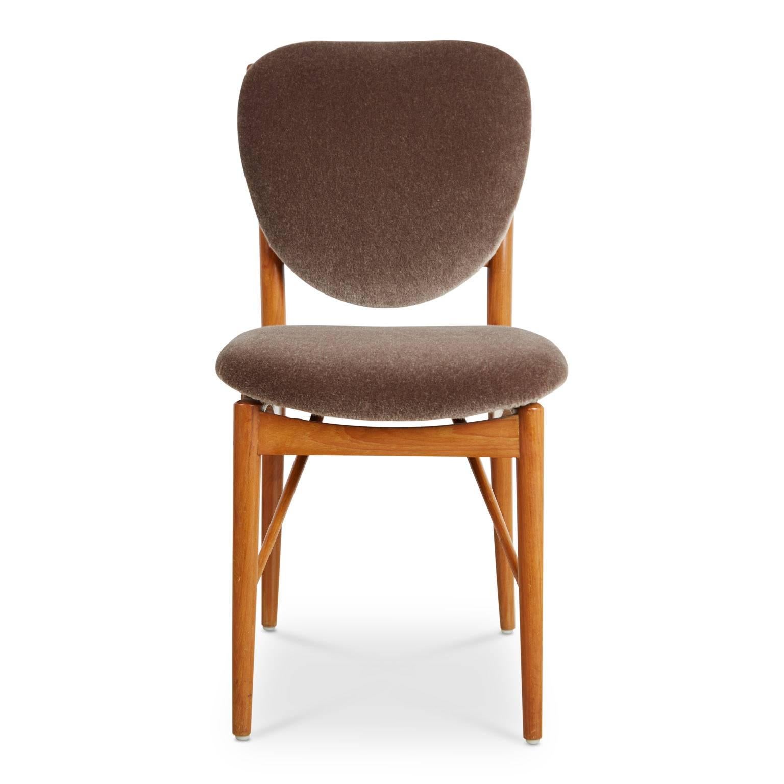 These Finn Juhl, and attributed to Bovirke, dining side chairs are gleaming with personality, character and charm and are an excellent example of the Danish architect and designer's work. 

The chairs feature teak frames consisting of clean lines
