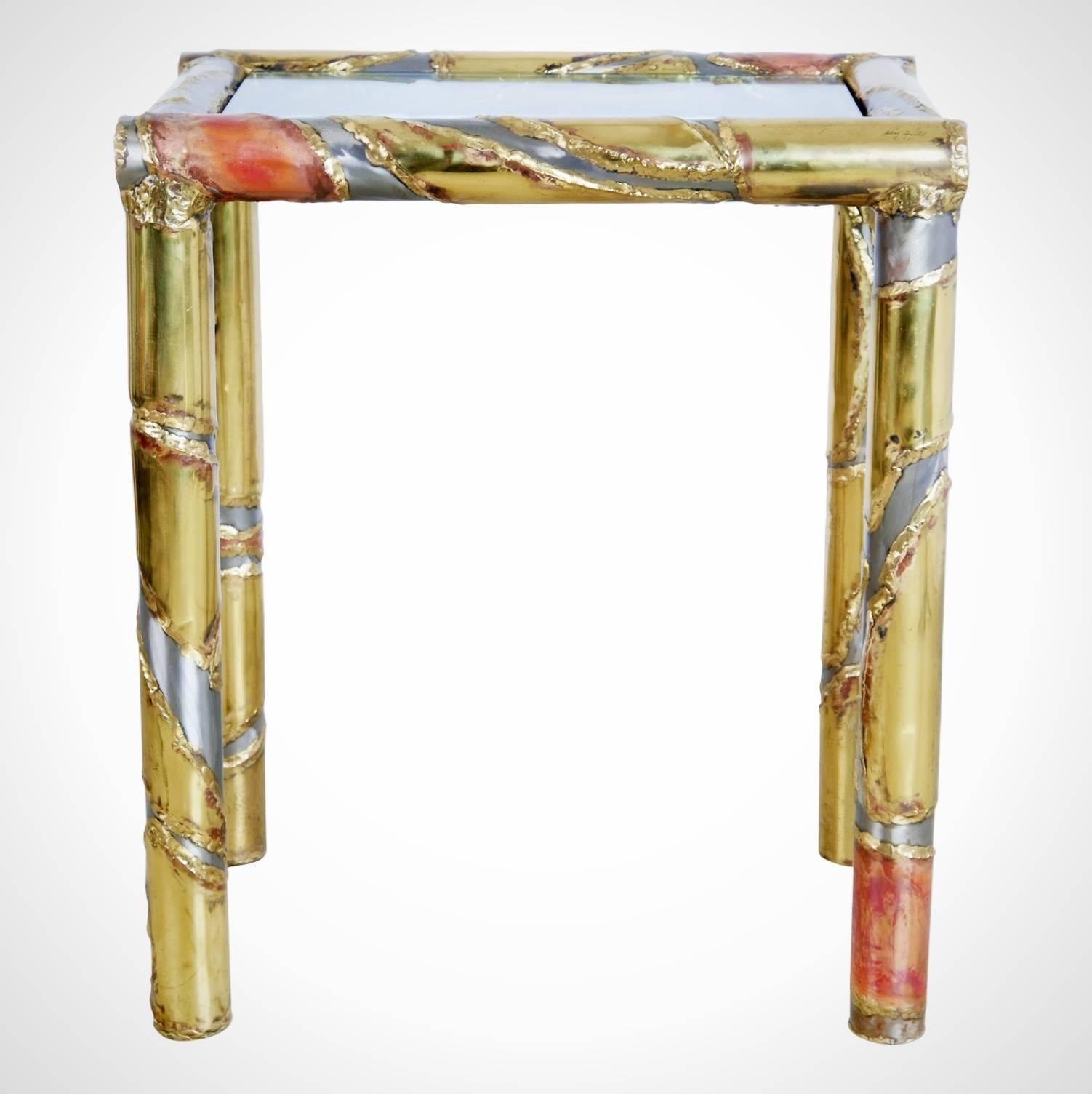 A rare signed and dated Silas Seandal console table comprised of a mix of raw solid metals including brass, bronze, steel and copper which have been applied by use of heat treatments and acids that Seandel has developed. All the colors on this piece