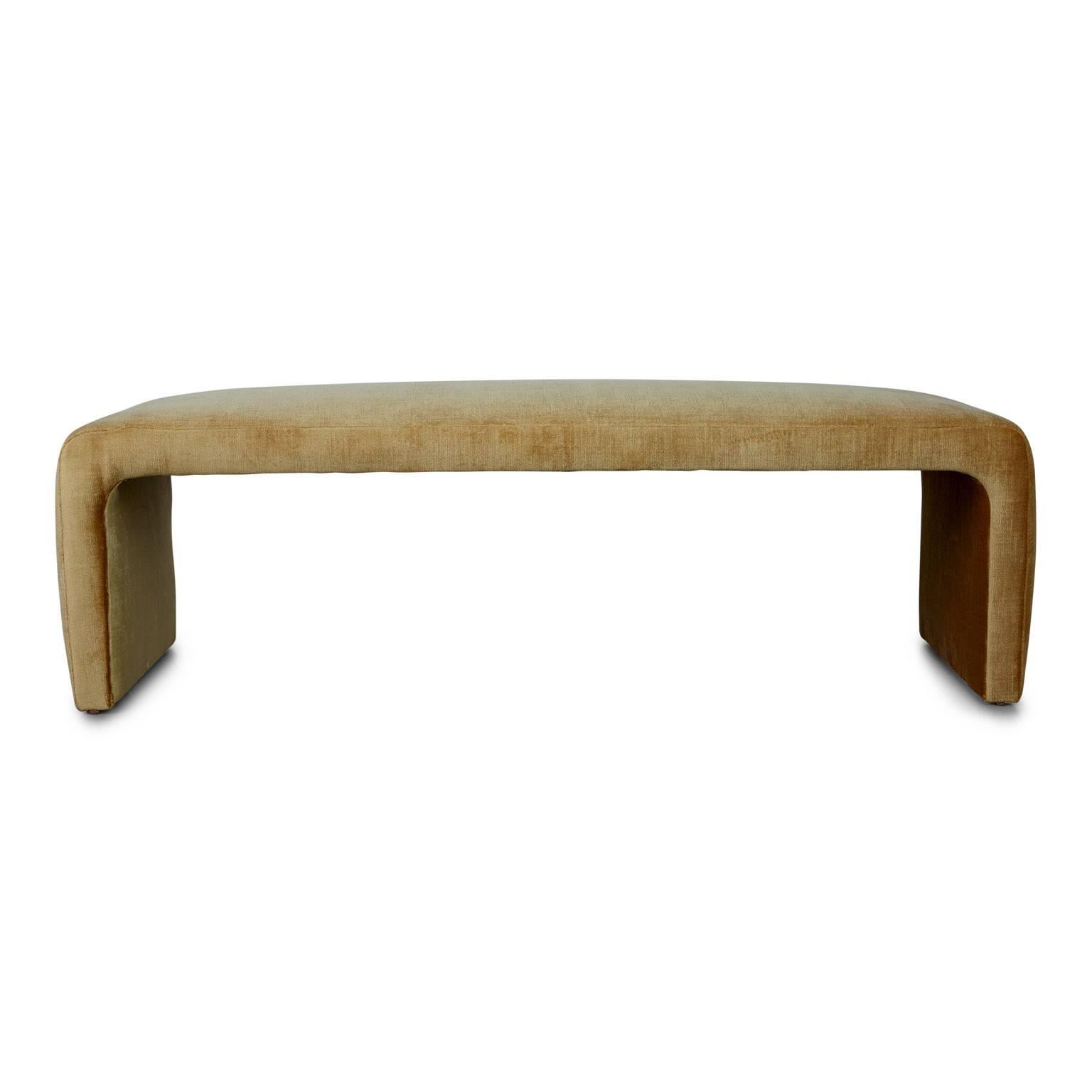 Lustrous pair of waterfall style benches that have been newly upholstered in high-end Schumacher gold cotton velvet. The simple clean lines of these benches along with their high end choice of upholstery fabric in one of the hottest interiors colors
