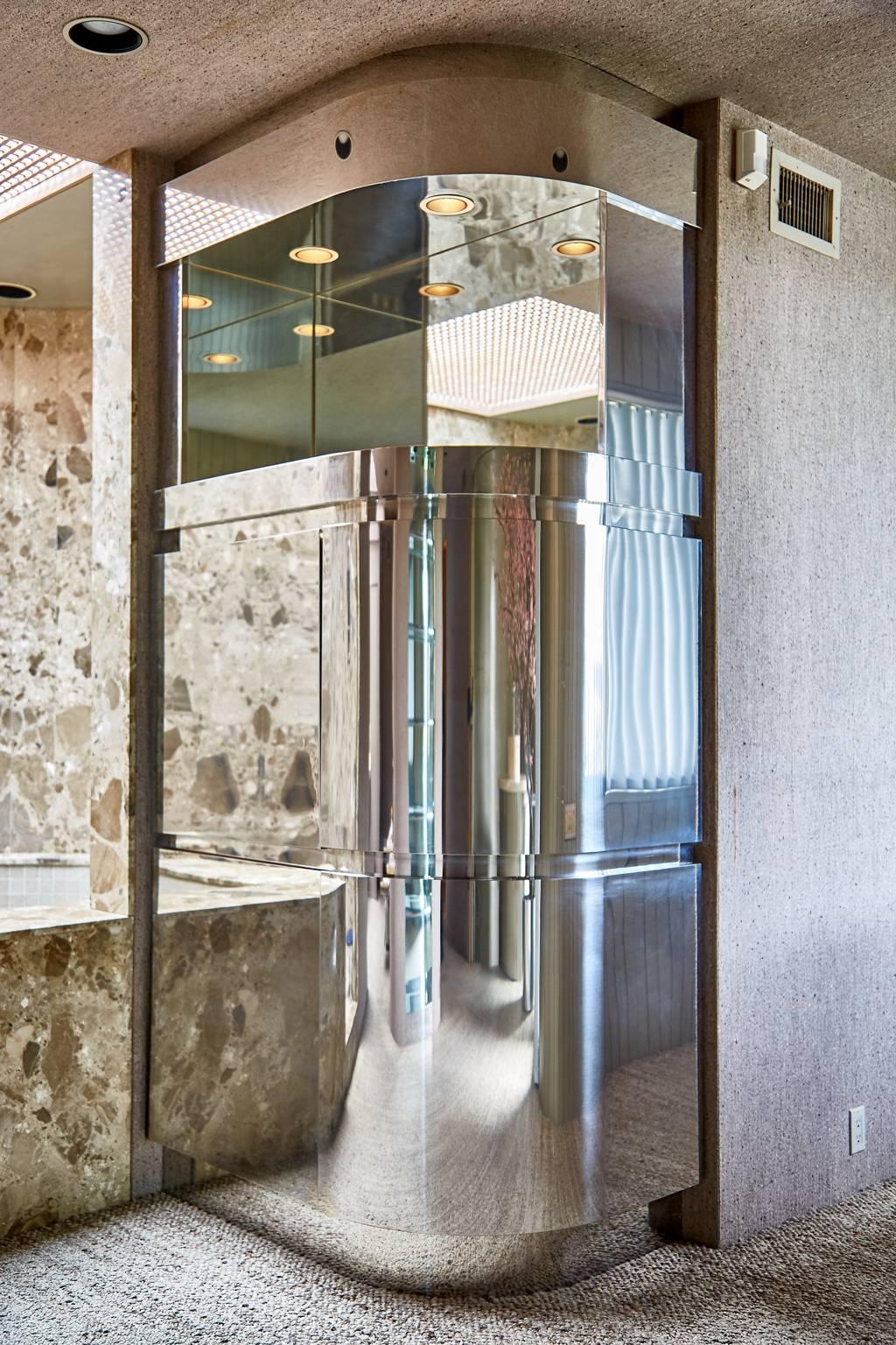 Invest in a piece of design history with this monumental chrome cabinet designed and commissioned by Steve Chase and built by Philip Socola, a cutting edge custom cabinets and furniture builder who has been commissioned to build many high end