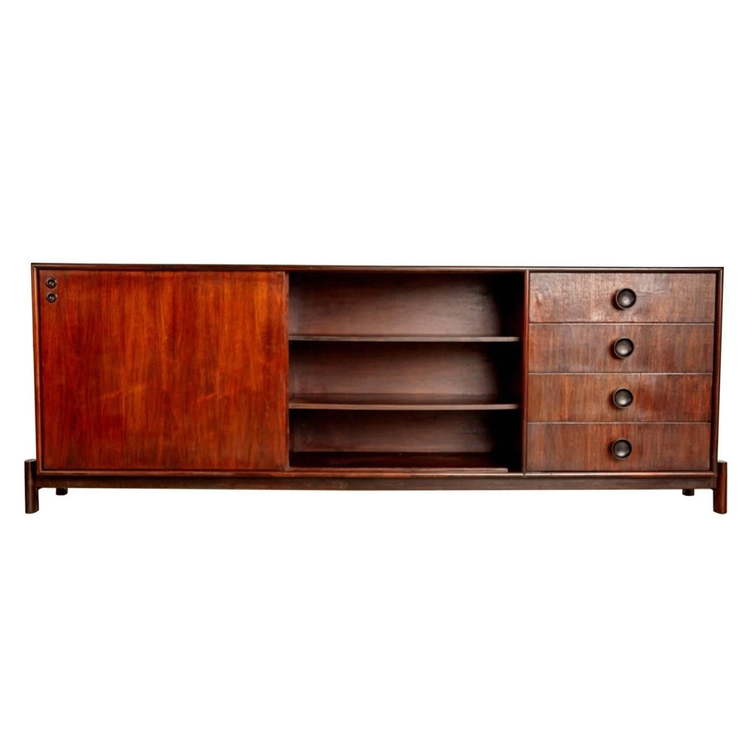 Newly imported from a private collector in Brazil, this impressive credenza by Carlo Hauner for Forma Brazil emulates the quality and innovation of Brazilian Modern design. Fabricated from dark Brazilian rosewood which shows a dramatic grain, this