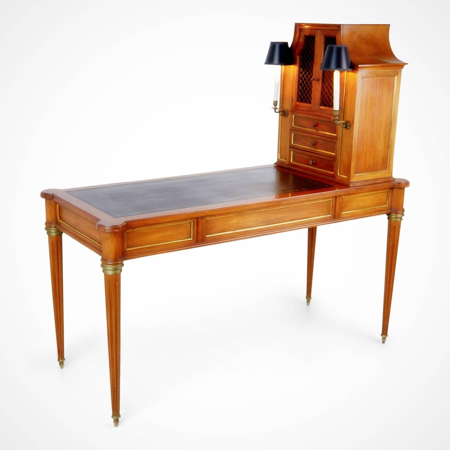 Beautifully detailed Louis XVI style bureau plat desk with side cabinet by Maison Jansen. Fabricated from walnut with reeded legs, embossed tooled black leather writing top and turret corners. This elegant desk also has three slim drawers on one