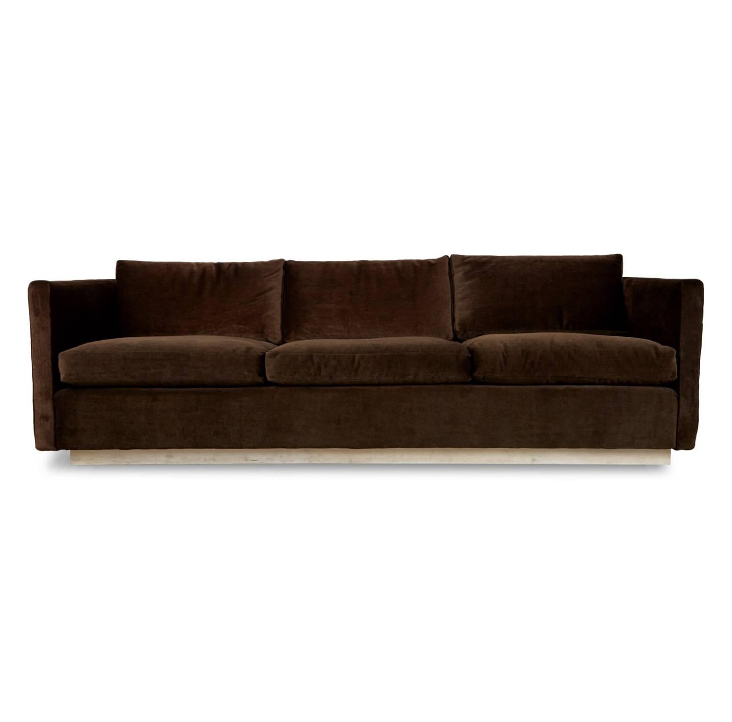 Wonderfully plush sofa attributed to Milo Baughman that has been recently restored and upholstered in a sumptuous rich chocolate brown mohair. This elegant sofa features clean lines, minimal design and a white base that contrasts with the fabric