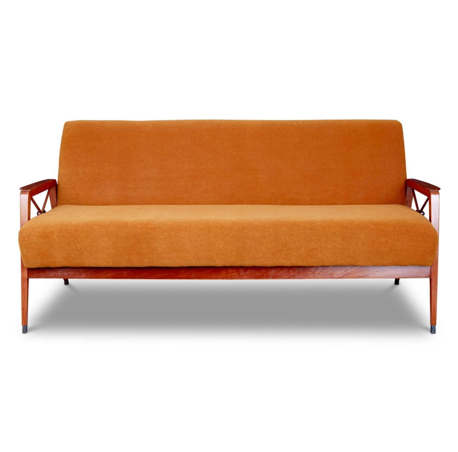 Elegant sofa with exotic Caviuna wood frame, new tangerine mohair upholstery, bronze-tipped feet and bronze medallions by Cavallaro, 1960s, Brazil. This exquisite Brazilian piece has been recently restored and reupholstered in a rich persimmon color